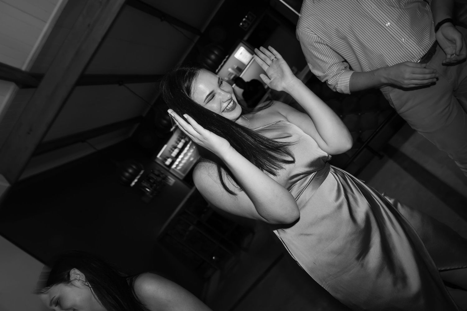 Party guest enjoying the dance floor in black and white photography.