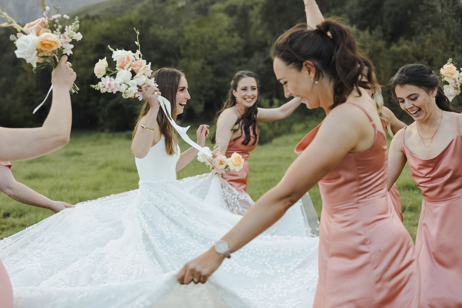 Candid celebration shots of bridal party in soft pink dresses.