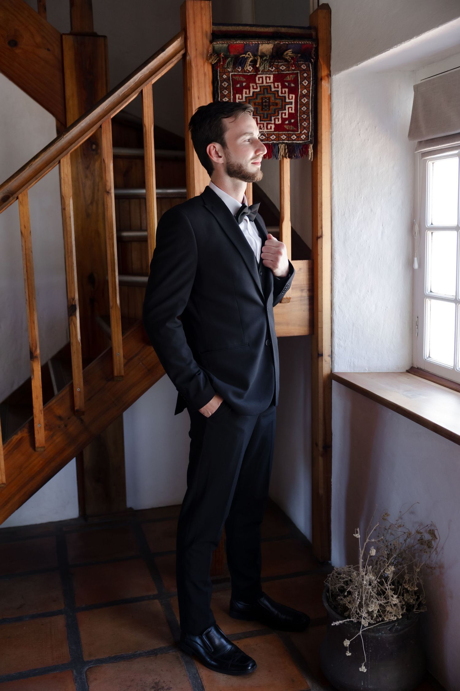 Artistic sequence showing someone in formal attire posing against wooden stairs and white walls.