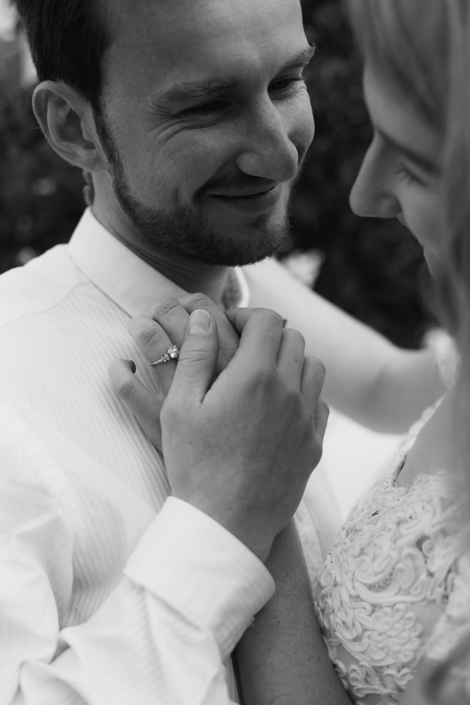 A romantic black and white wedding photo series showing tender moments between a couple in formal attire.