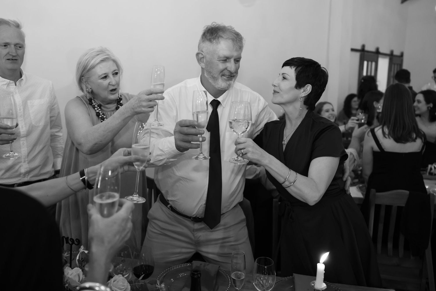 A series of black and white photos showing couples dancing together at what appears to be a wedding reception or party.