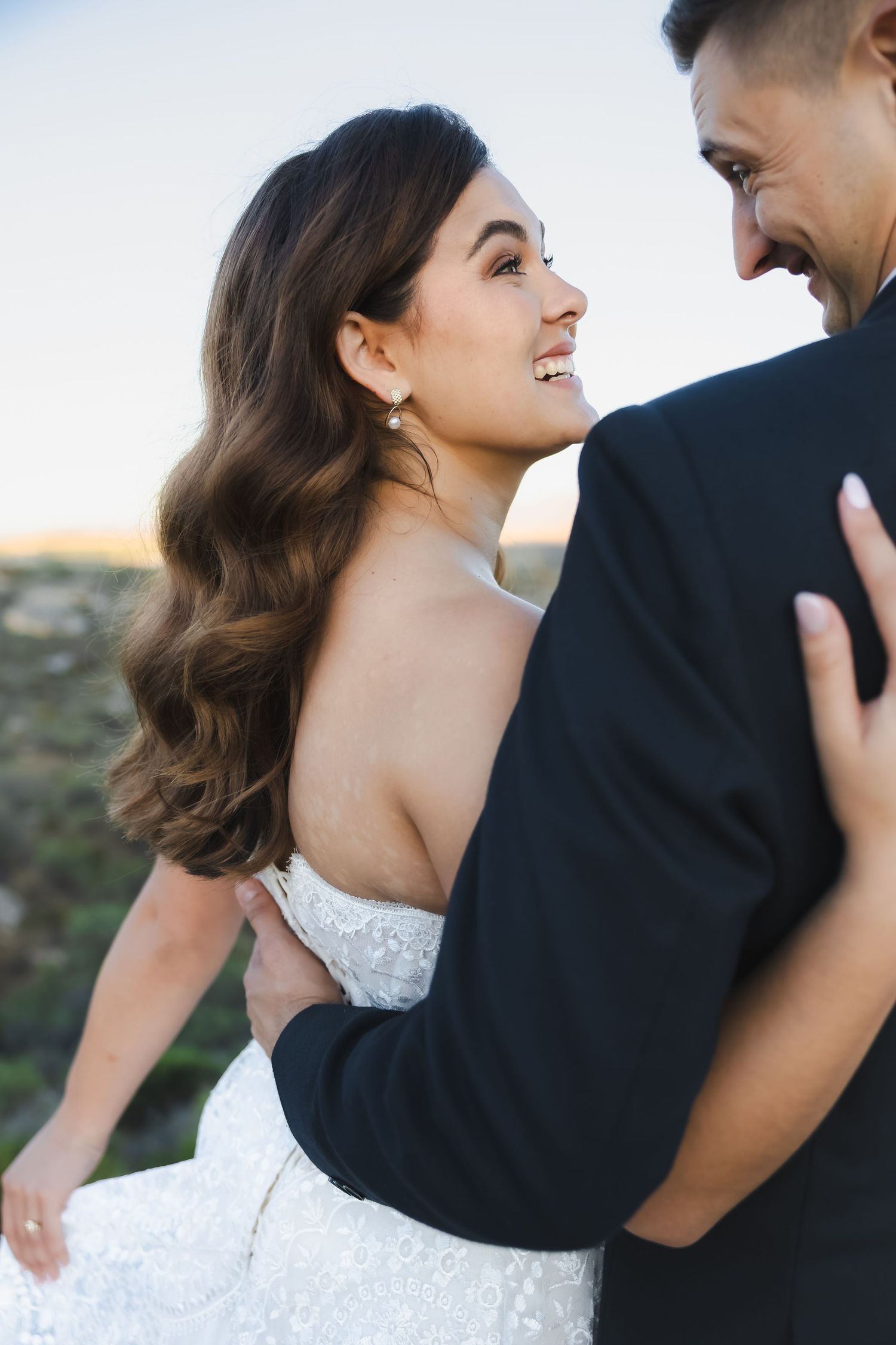 Close-up candid shot of joyful couple sharing laughter during their wedding photoshoot.