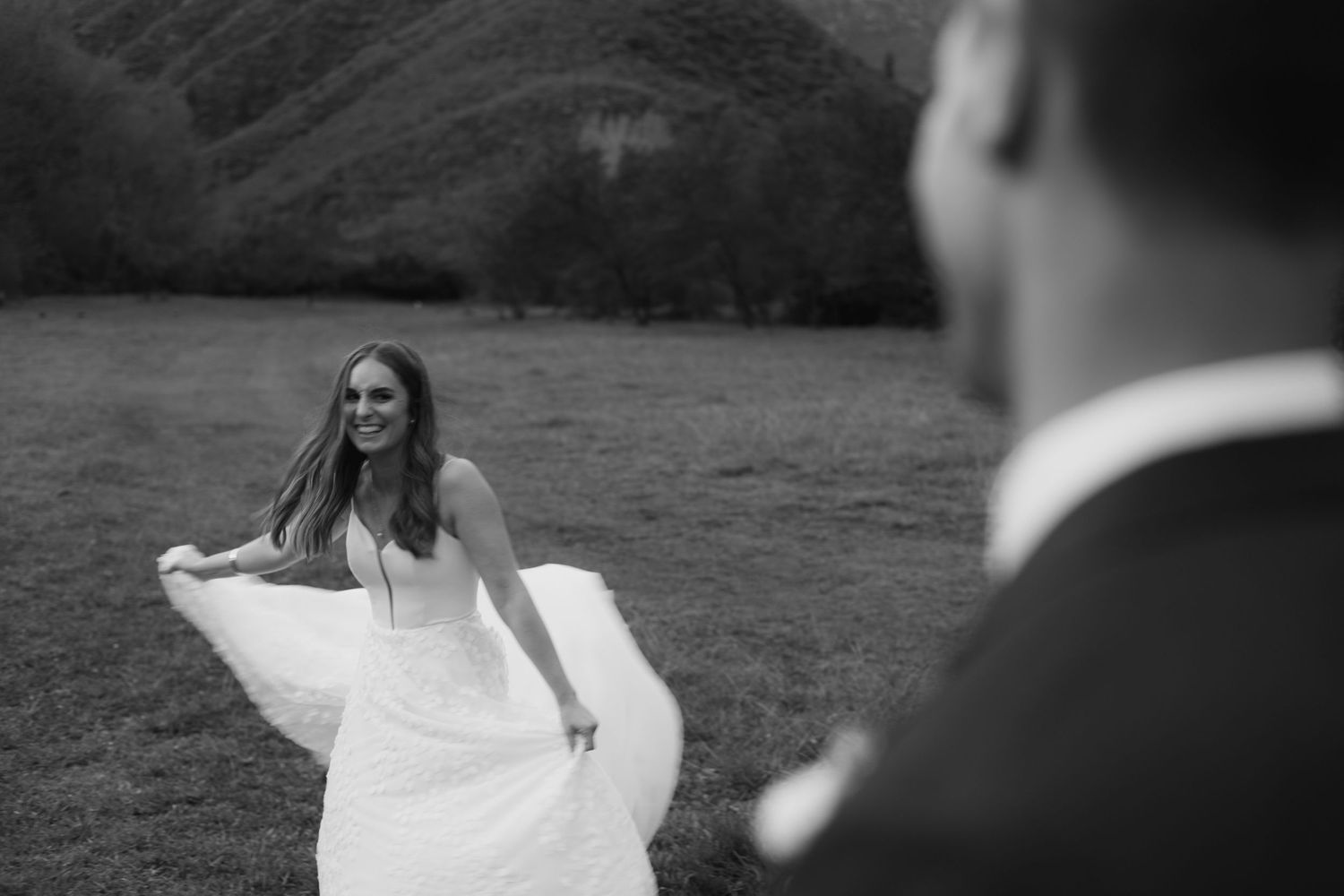 Black and white portrait of a couple sharing an intimate moment in their wedding attire.