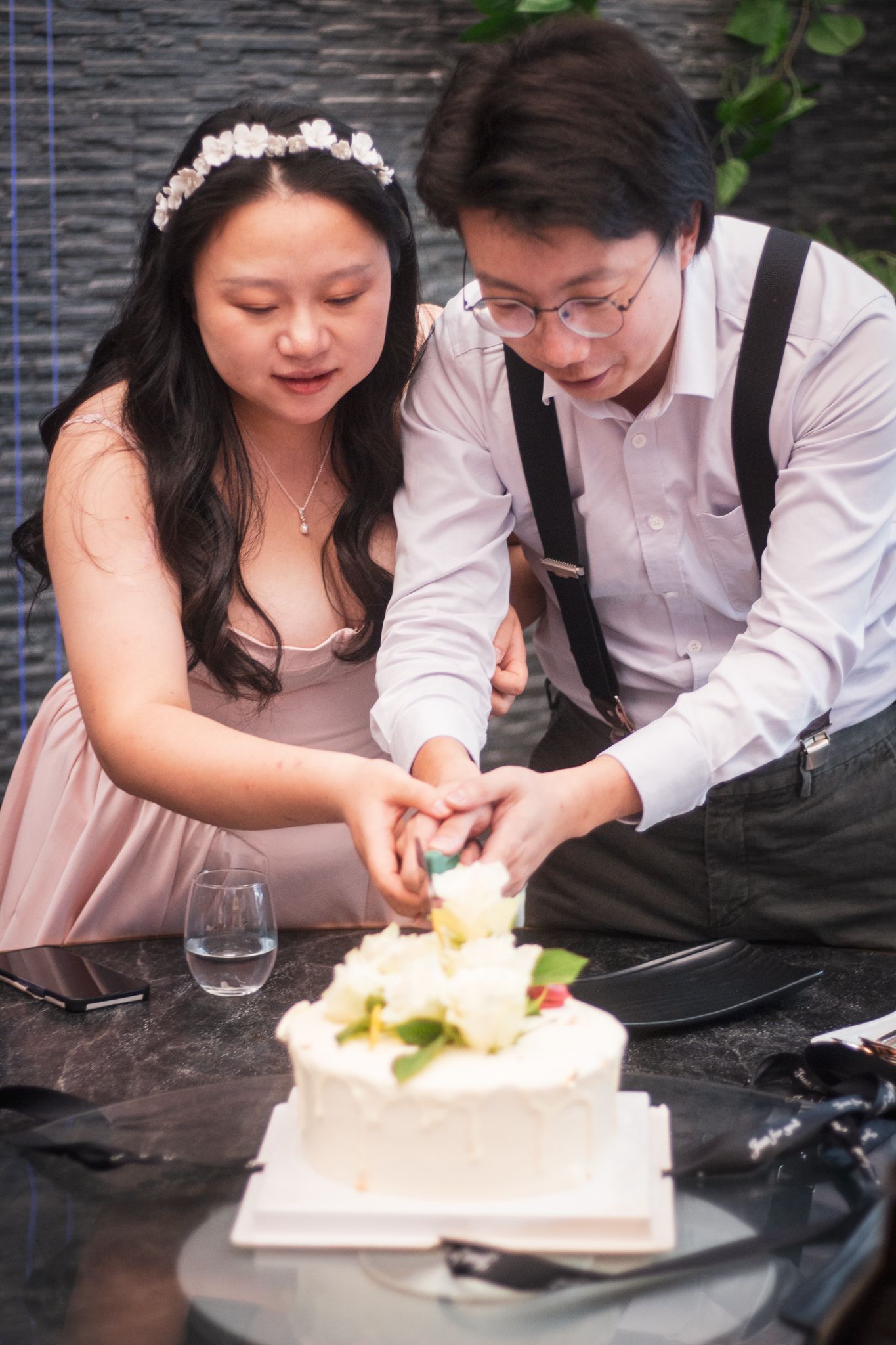 a couple cut the cake on their wedding day