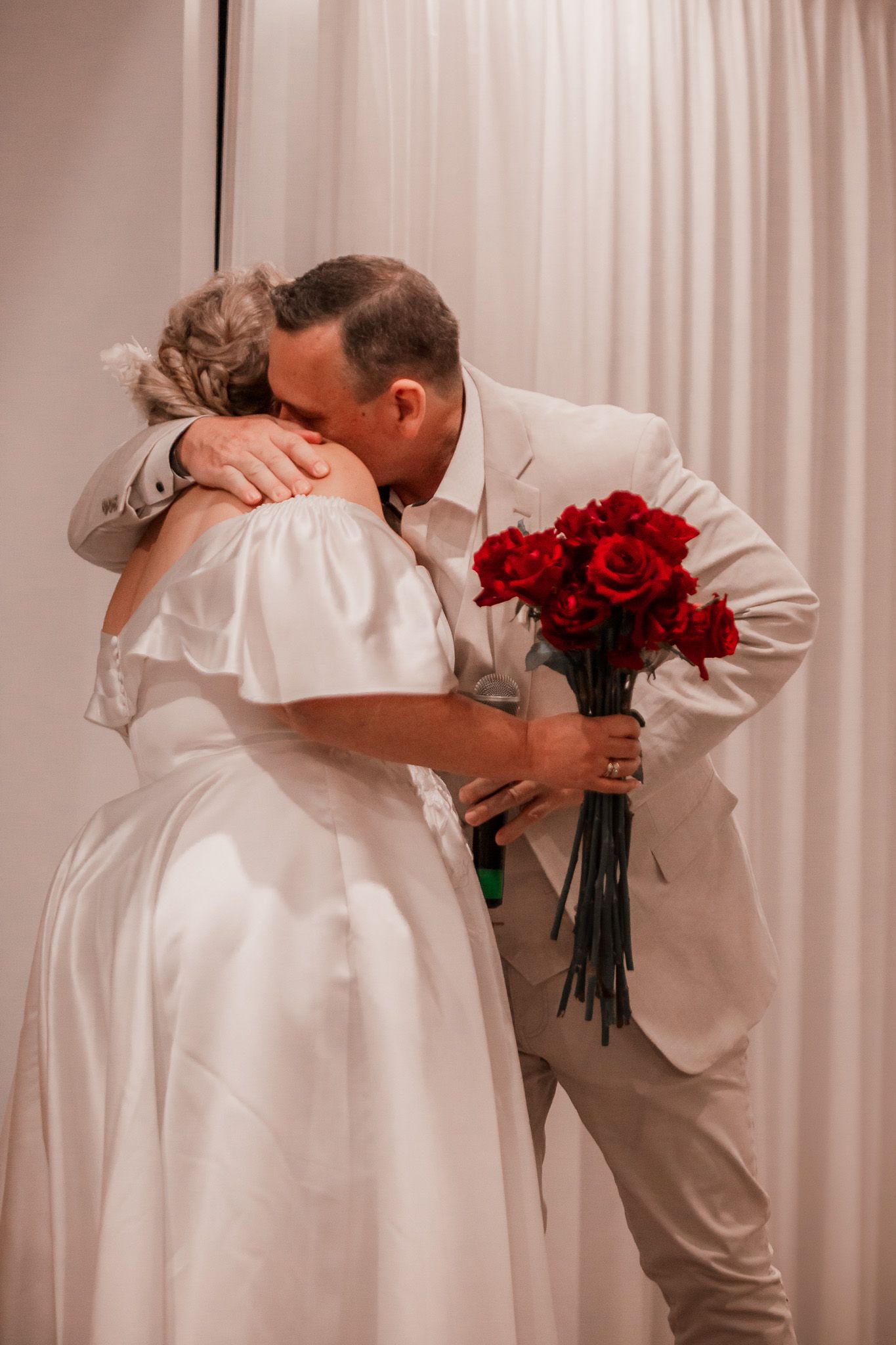 a couple at a vow renewal share a tender hug