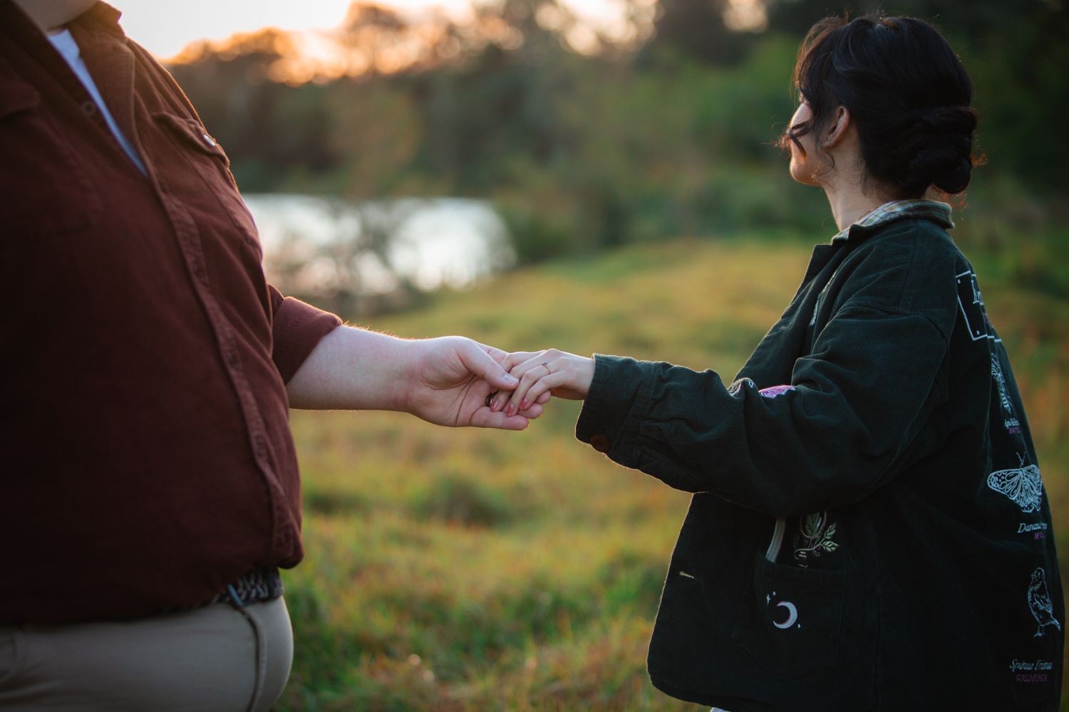 a couple look lovingly at each other at their pre wedding photoshoot. The bride-to-be shows off her ring
