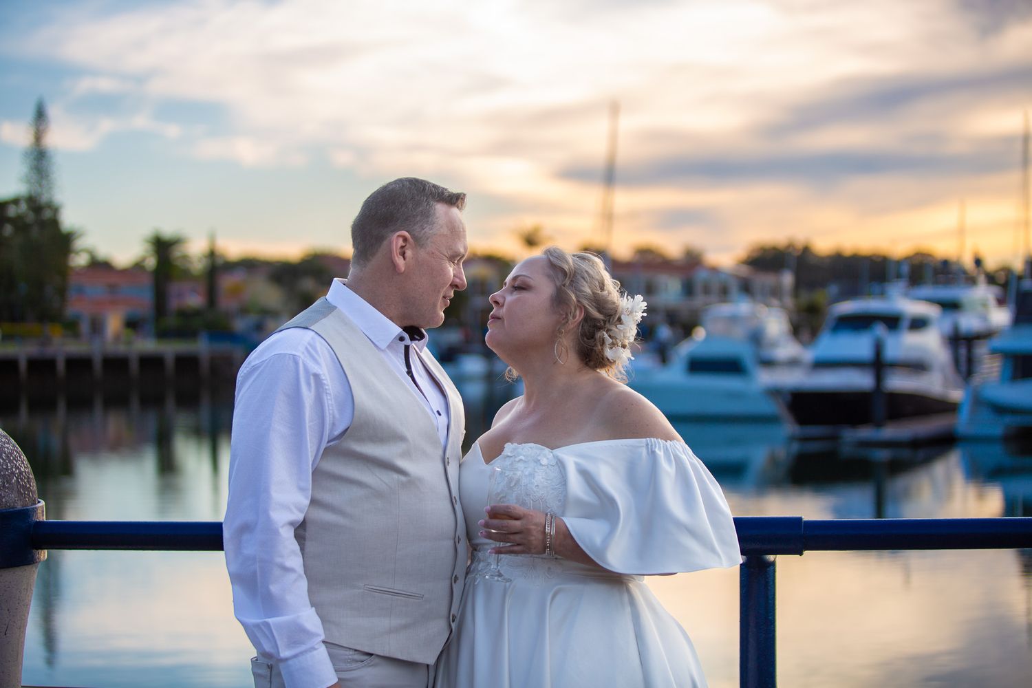 a couple look lovingly at each other while posing for a photo at their vow renewal