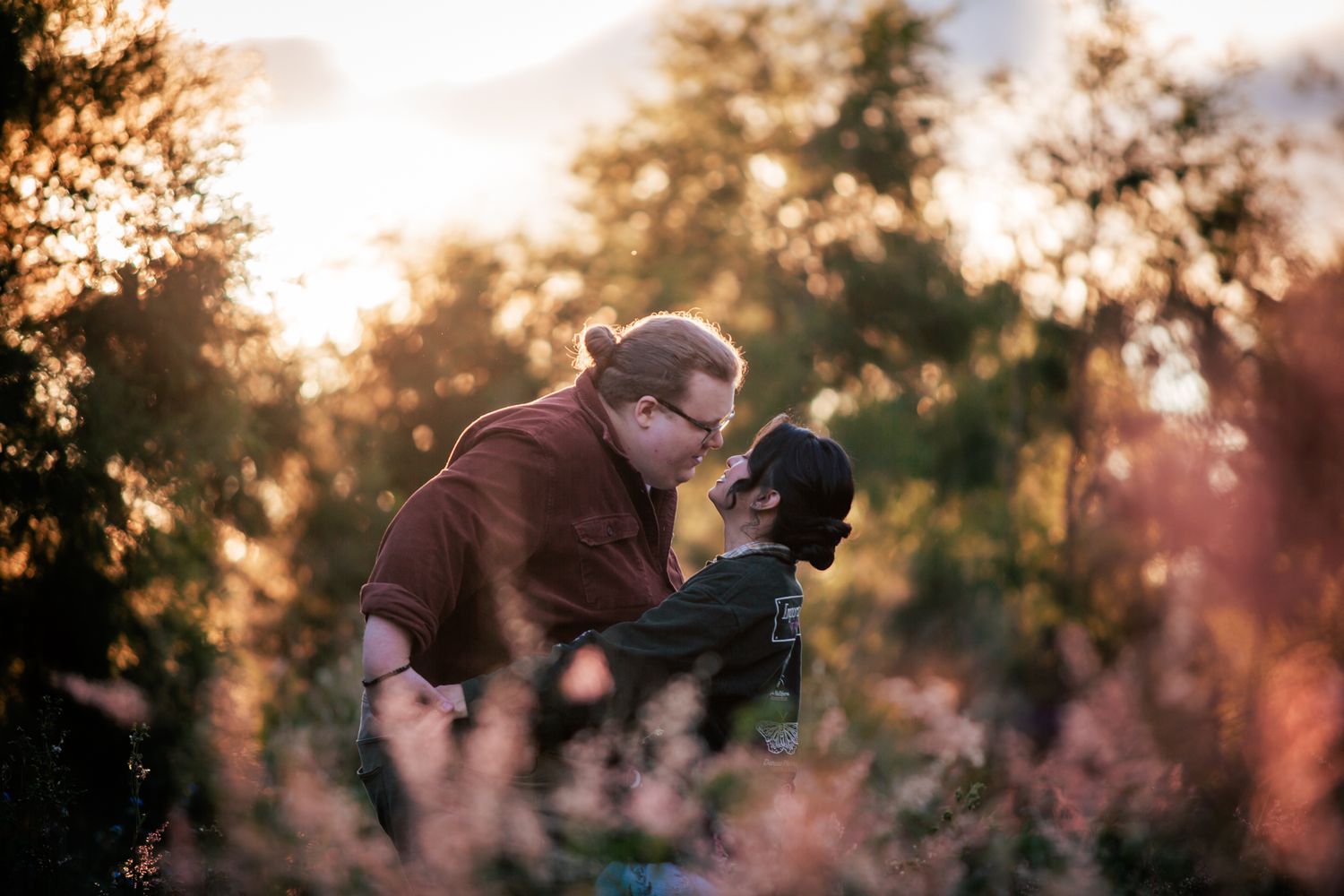 a couple look lovingly at each other at their playful pre wedding photoshoot