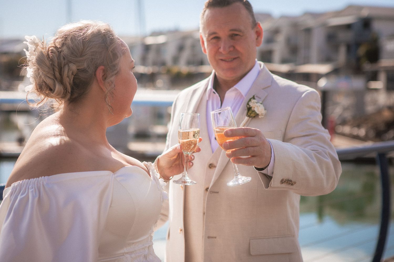 a couple look lovingly at each other while posing for a photo at their vow renewal