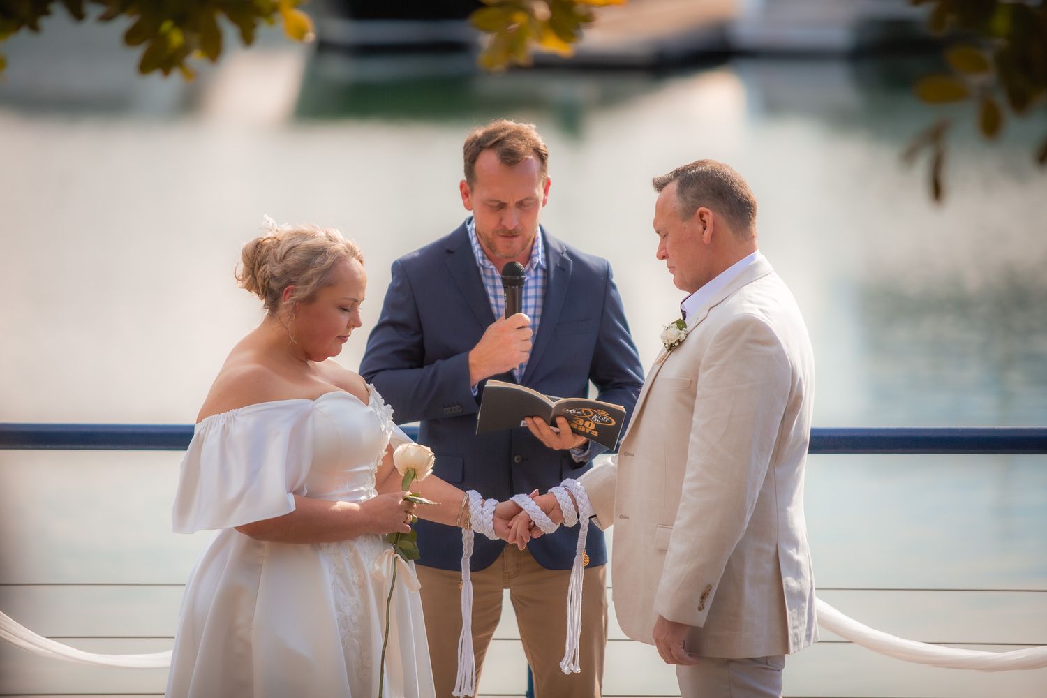 a couple look lovingly at each other while posing for a photo at their vow renewal