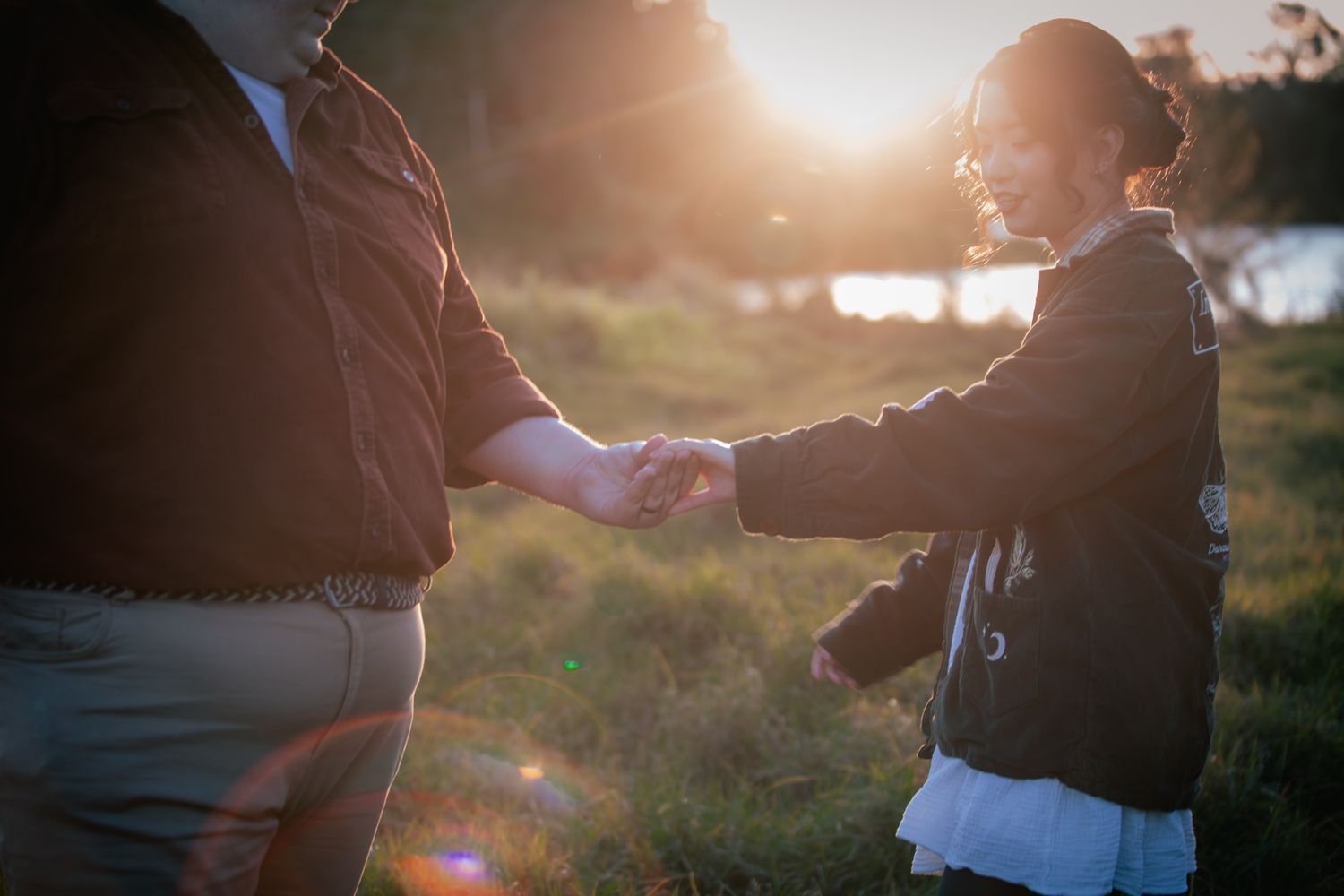 a couple look lovingly at each other at their pre wedding photoshoot. The bride-to-be shows off her ring