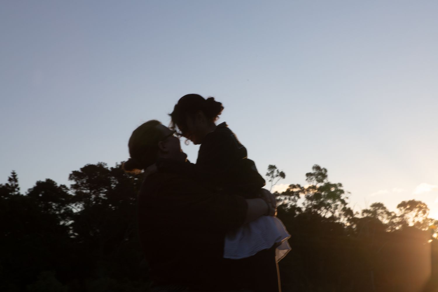 a couple look lovingly at each other at their playful pre wedding photoshoot