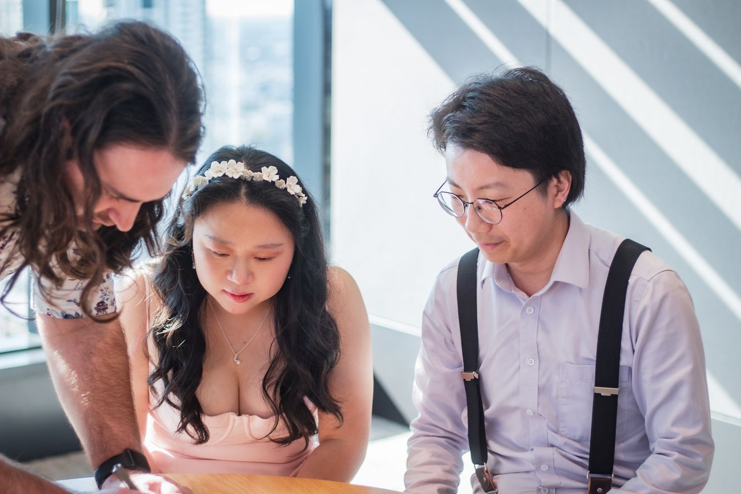 a photo of a couple signing legal documents on their wedding day