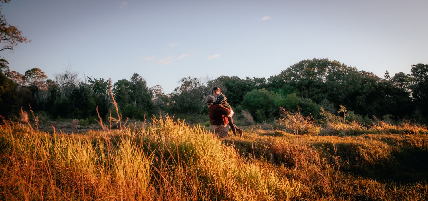 a couple look lovingly at each other at their playful pre wedding photoshoot