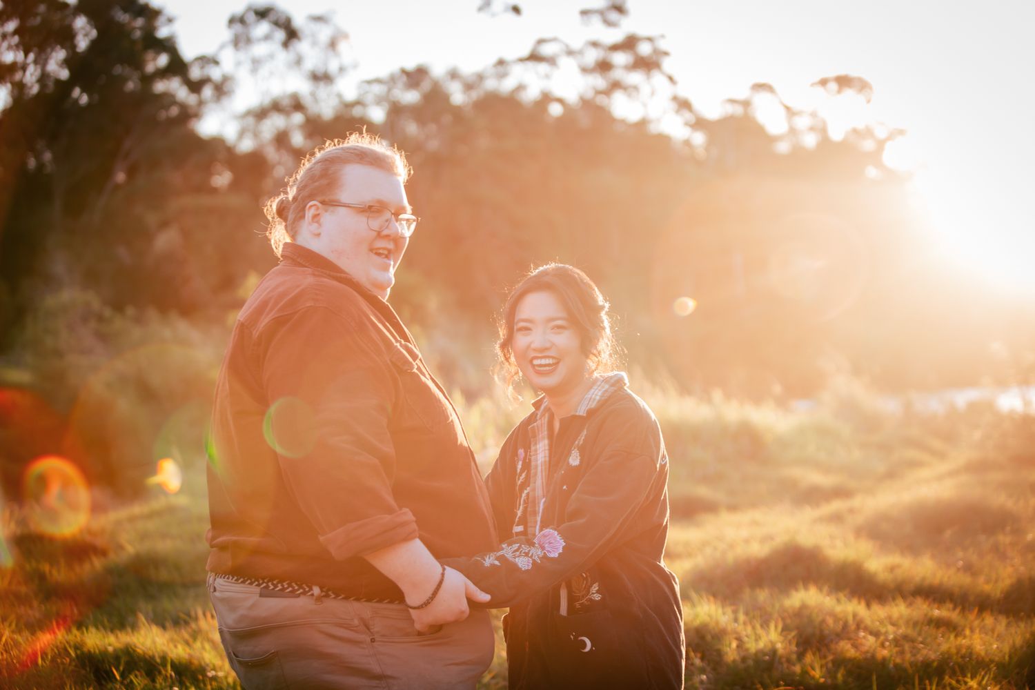 a couple laugh with each other at their playful pre wedding photoshoot