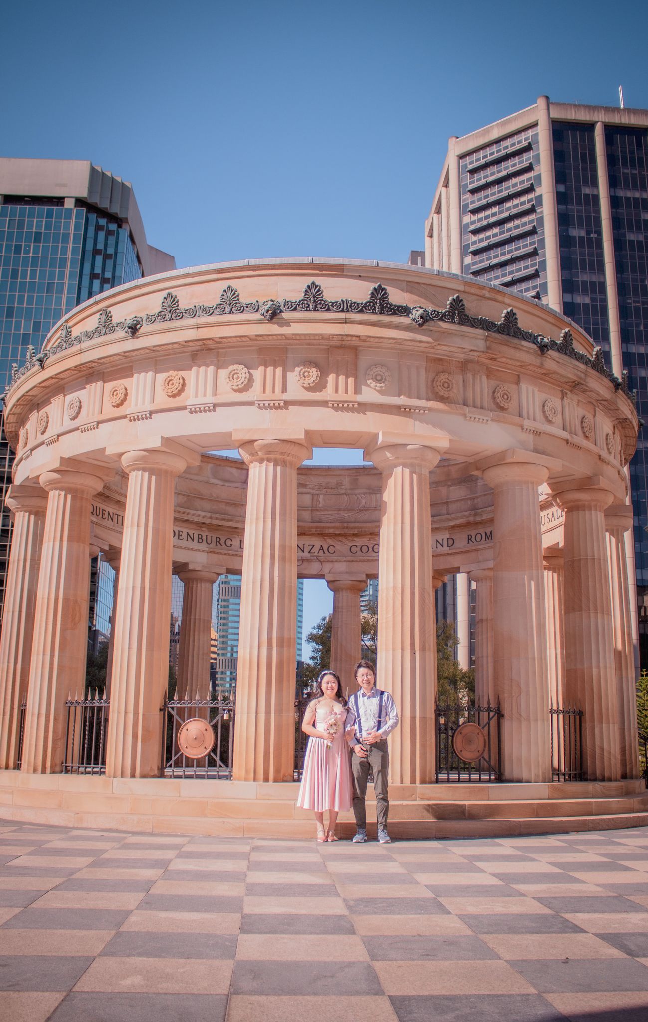 a couple pose for photos on their wedding day