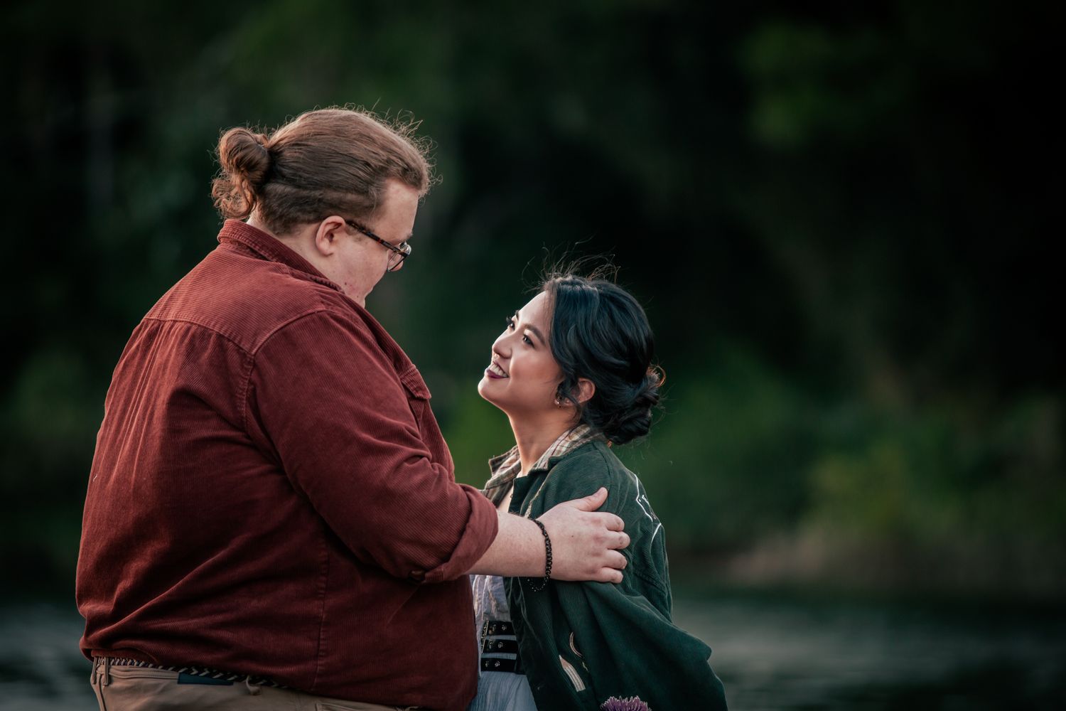 a couple look lovingly at each other at their pre wedding photoshoot
