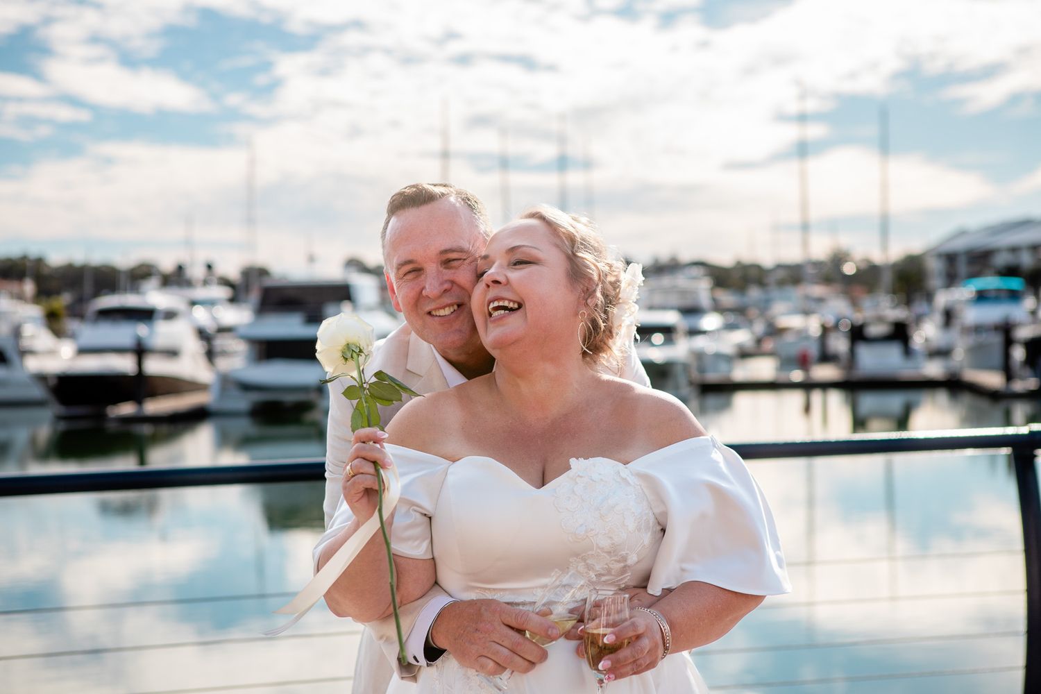 a couple laugh while posing for a photo at their vow renewal