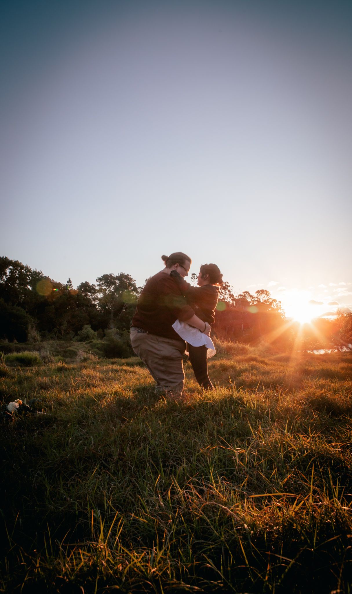 a couple look lovingly at each other at their playful pre wedding photoshoot