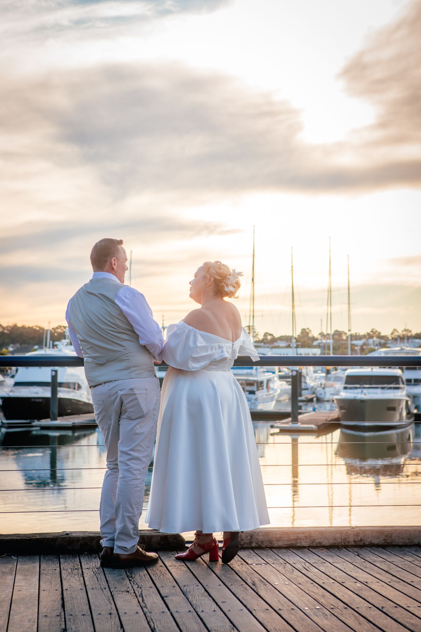 a couple look lovingly at each other while posing for a photo at their vow renewal