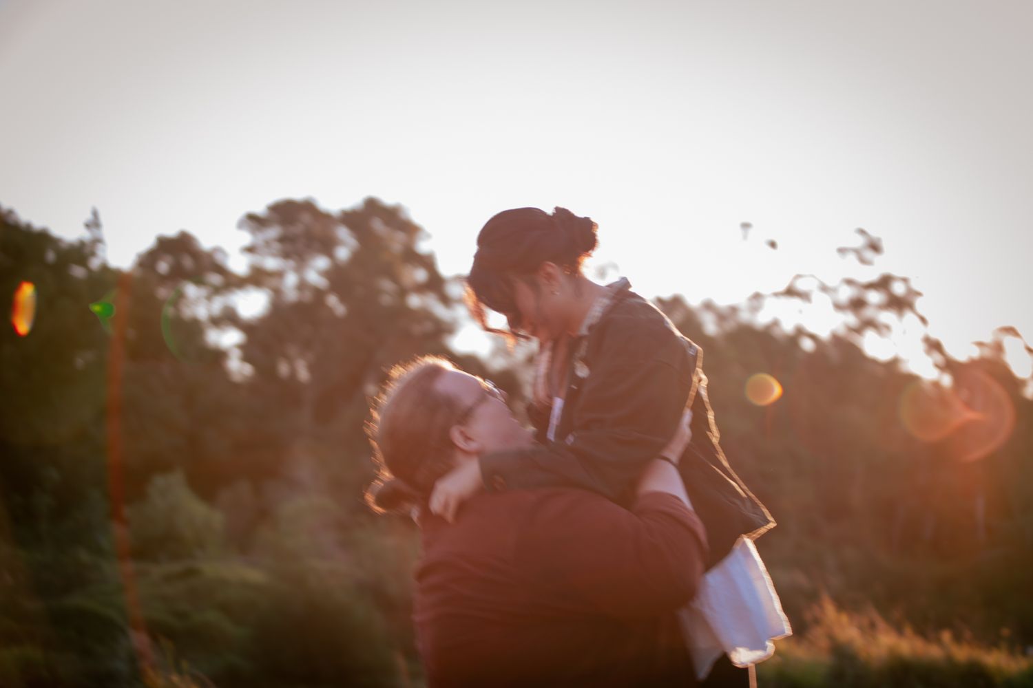 a couple look lovingly at each other at their playful pre wedding photoshoot