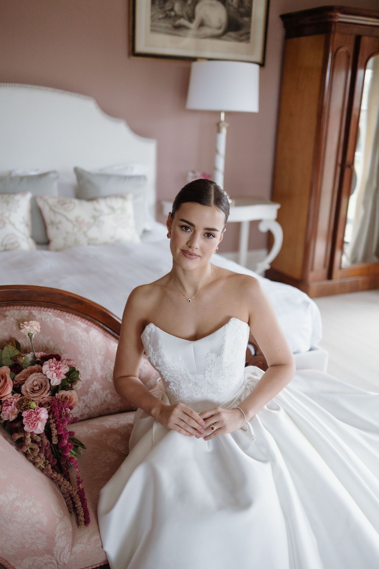 Bride adjusting her dress before walking down the aisle whilst at Berwick House