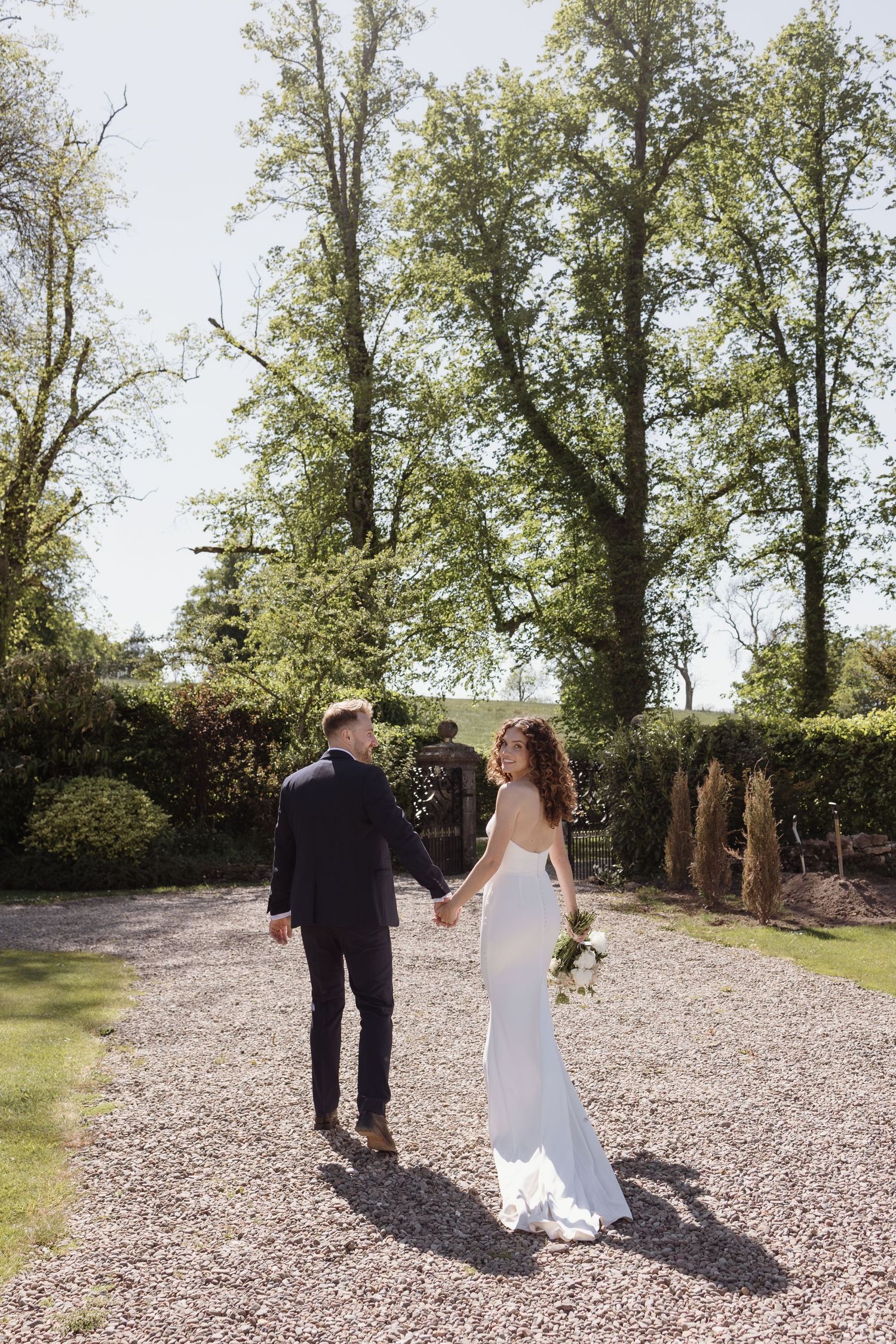 Couple walking through gardens at Holesfoot
