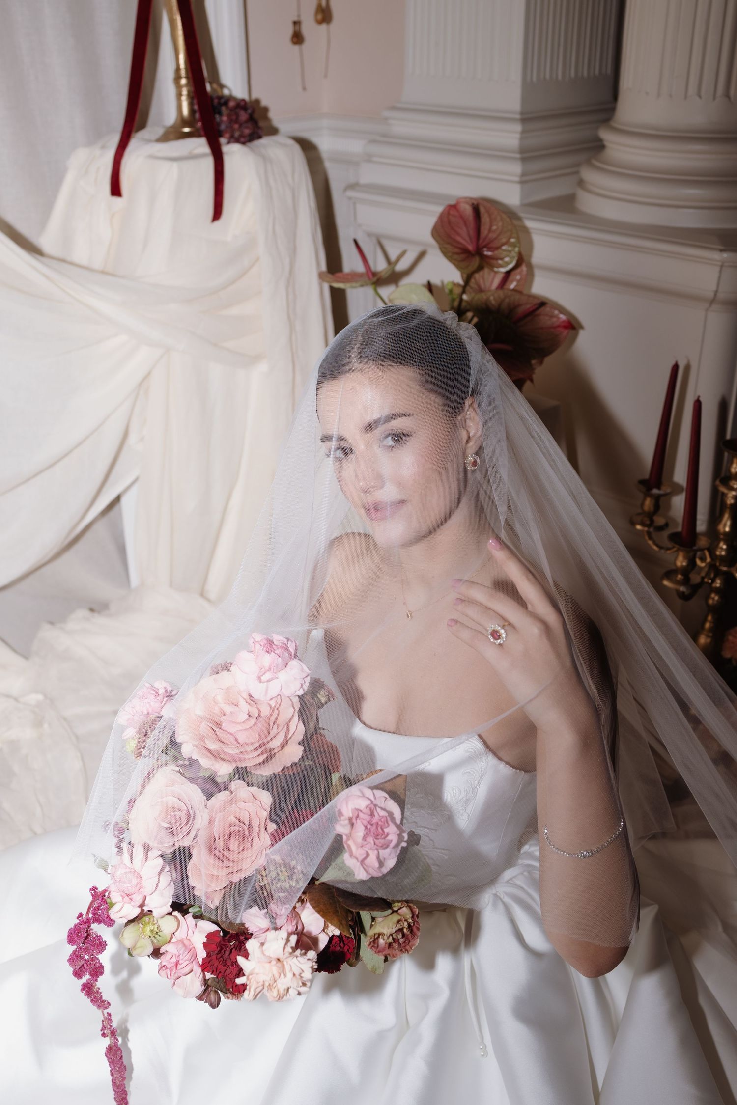 Bride holding bouquet filled with blush roses and greenery