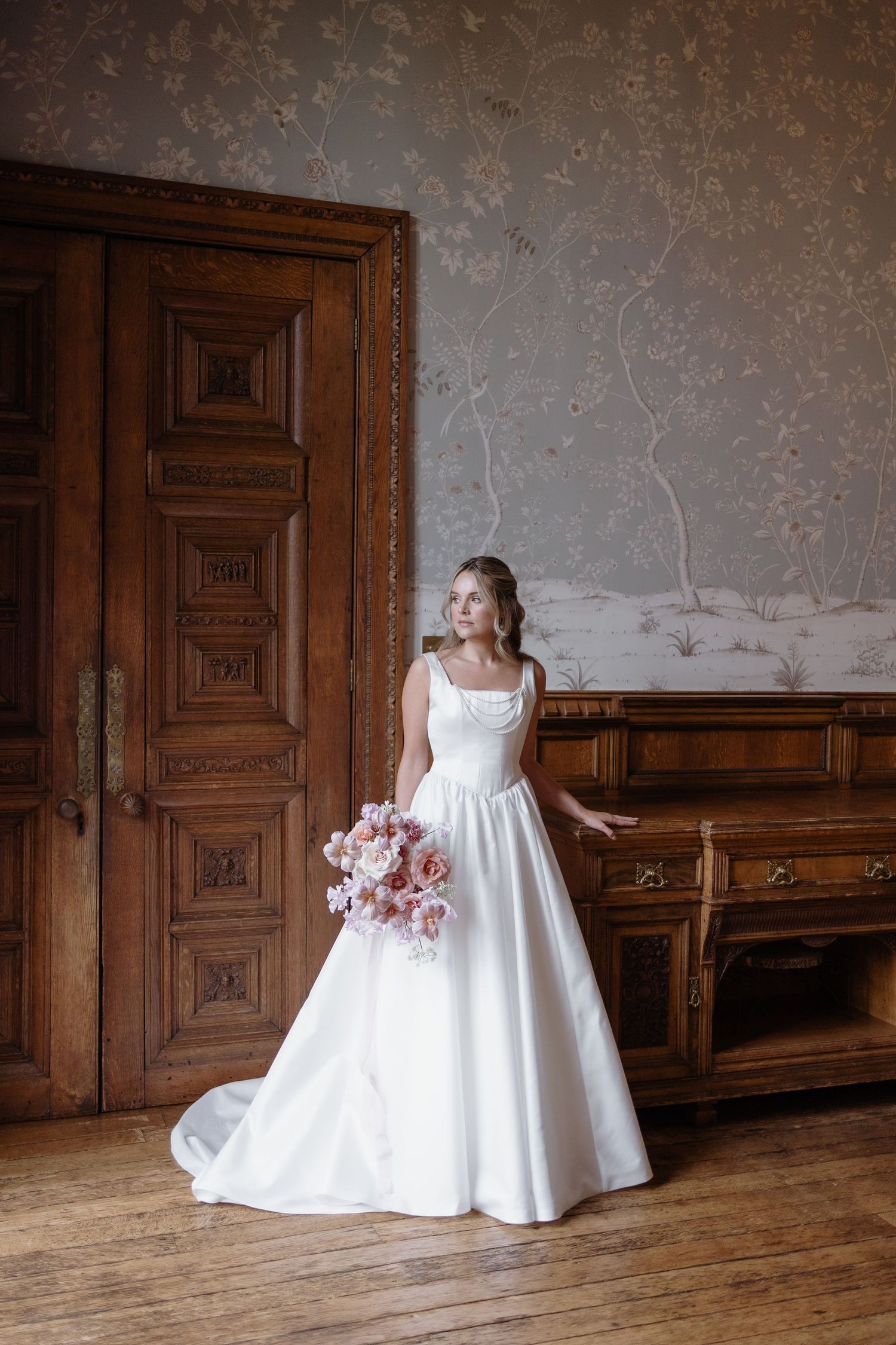 Bride walking through hallway of Soughton Hall before ceremony