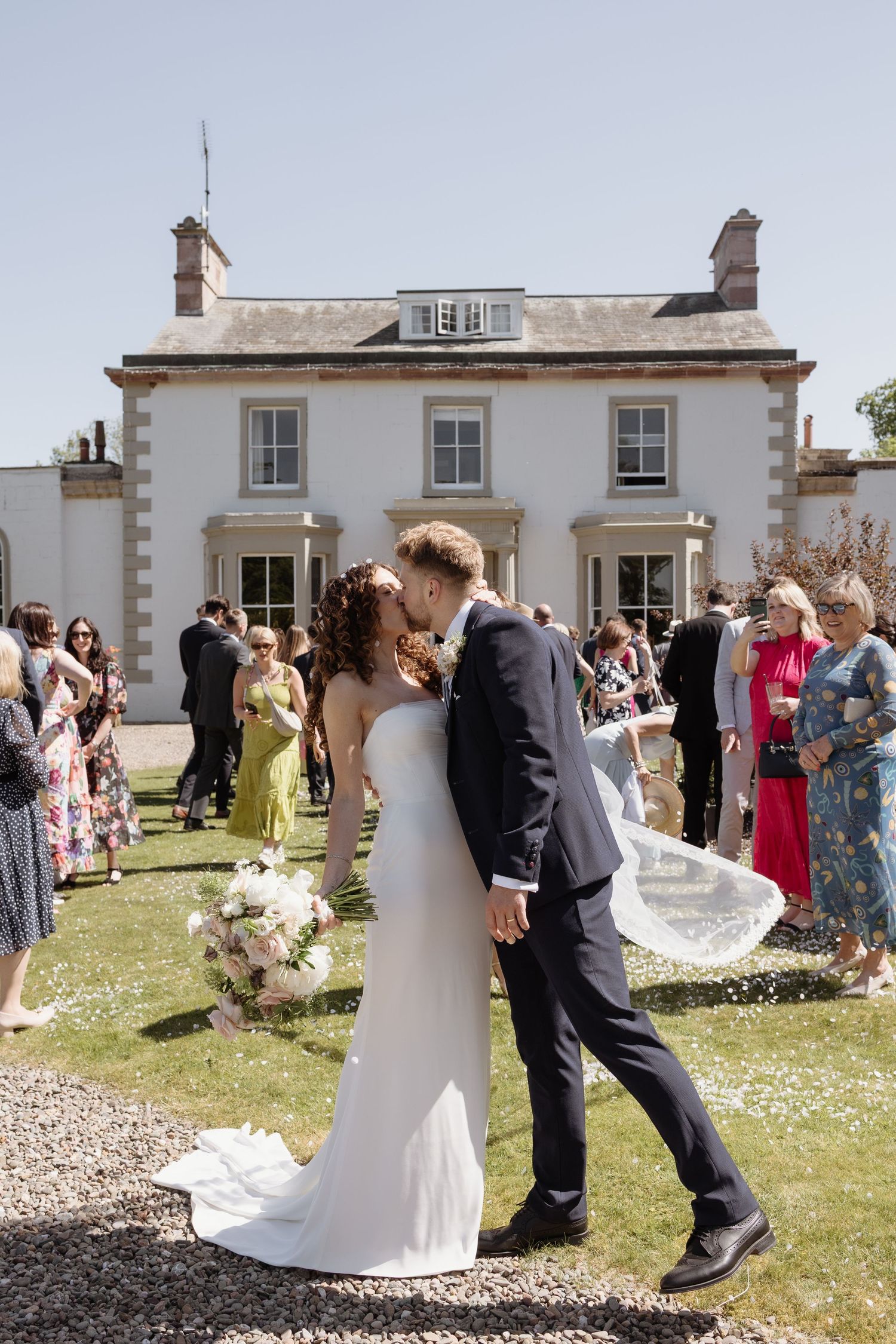 Couple kiss after confetti line at Holesfoot