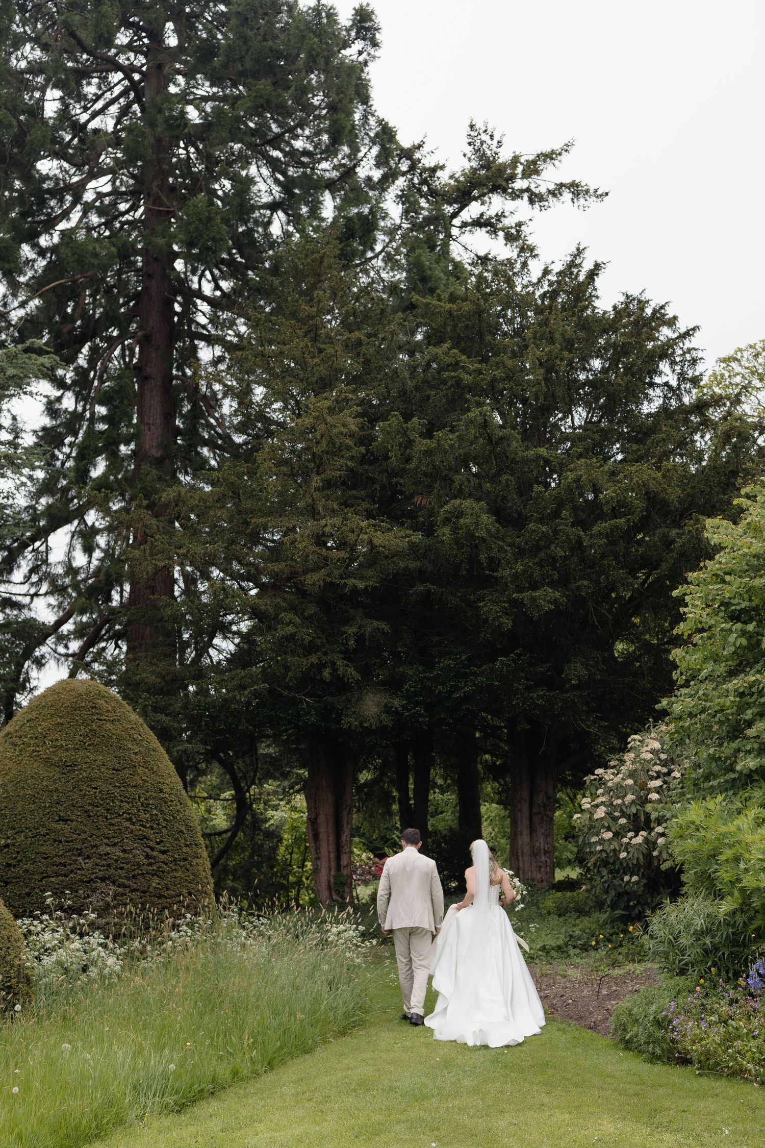 couple walking near Delamere on their wedding day