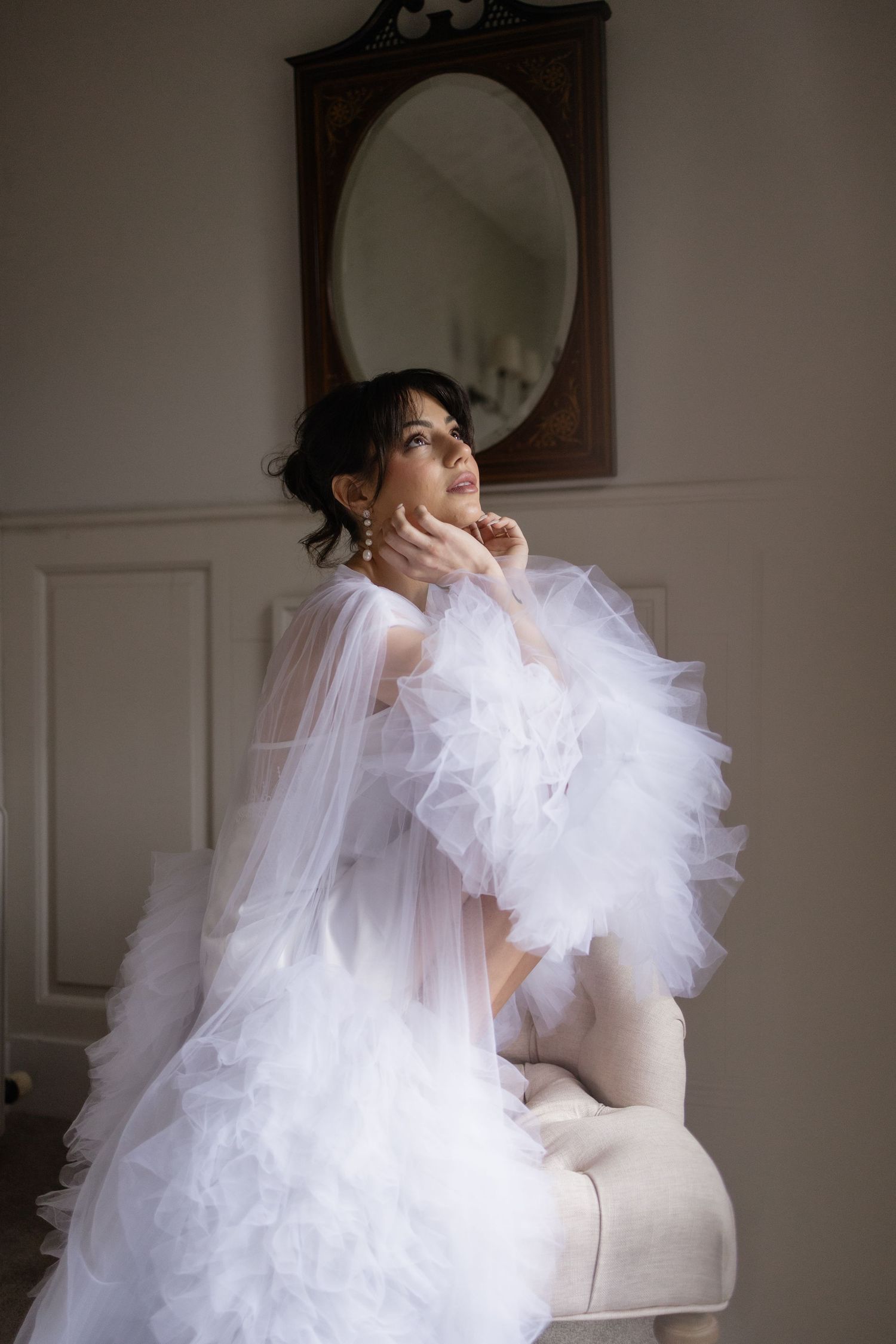 lovely moment of bride alone before her outdoor ceremony in the secret garden of Soughton Hall