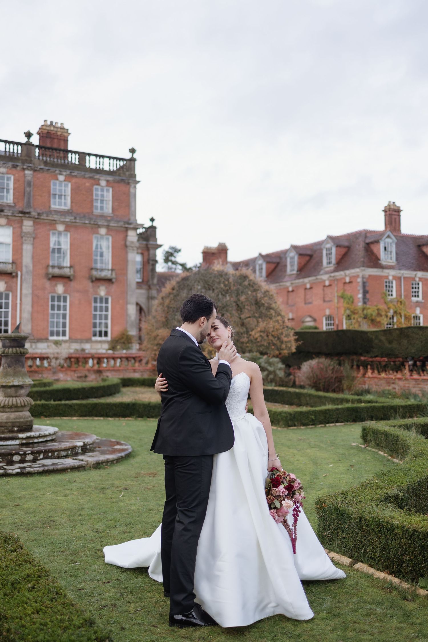Couple embracing in grounds at Berwick House