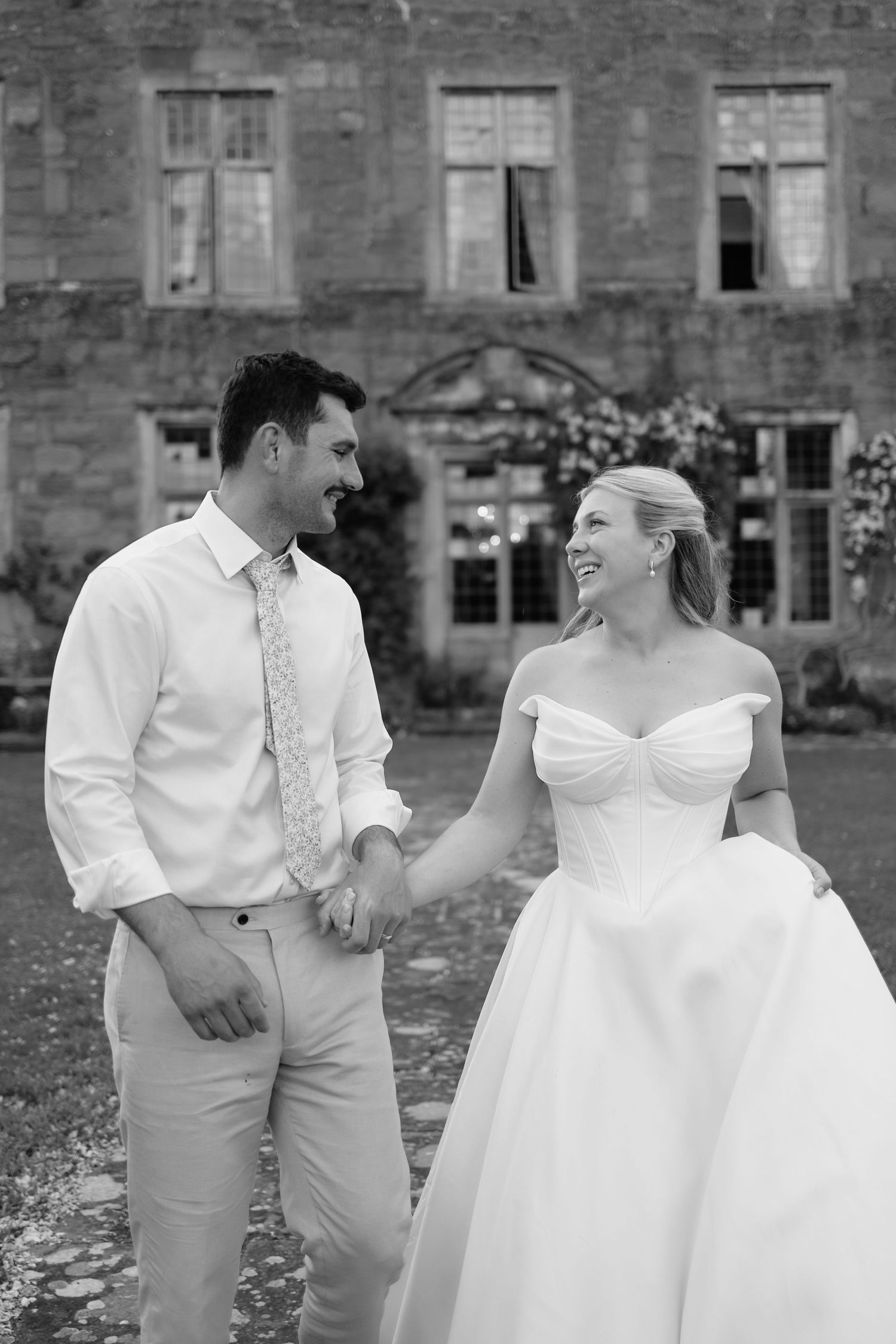 Bride and groom walking in the grounds of Askham Hall