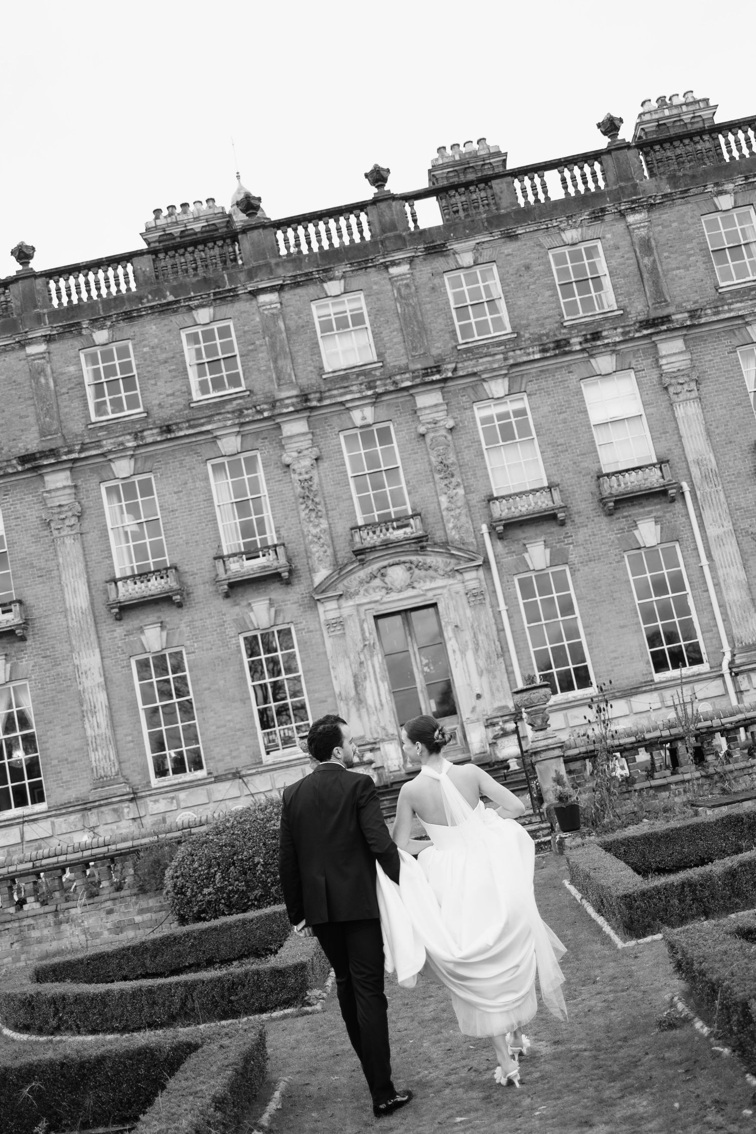 Bride and Groom waiting on the steps of Berwick House in Shropshire