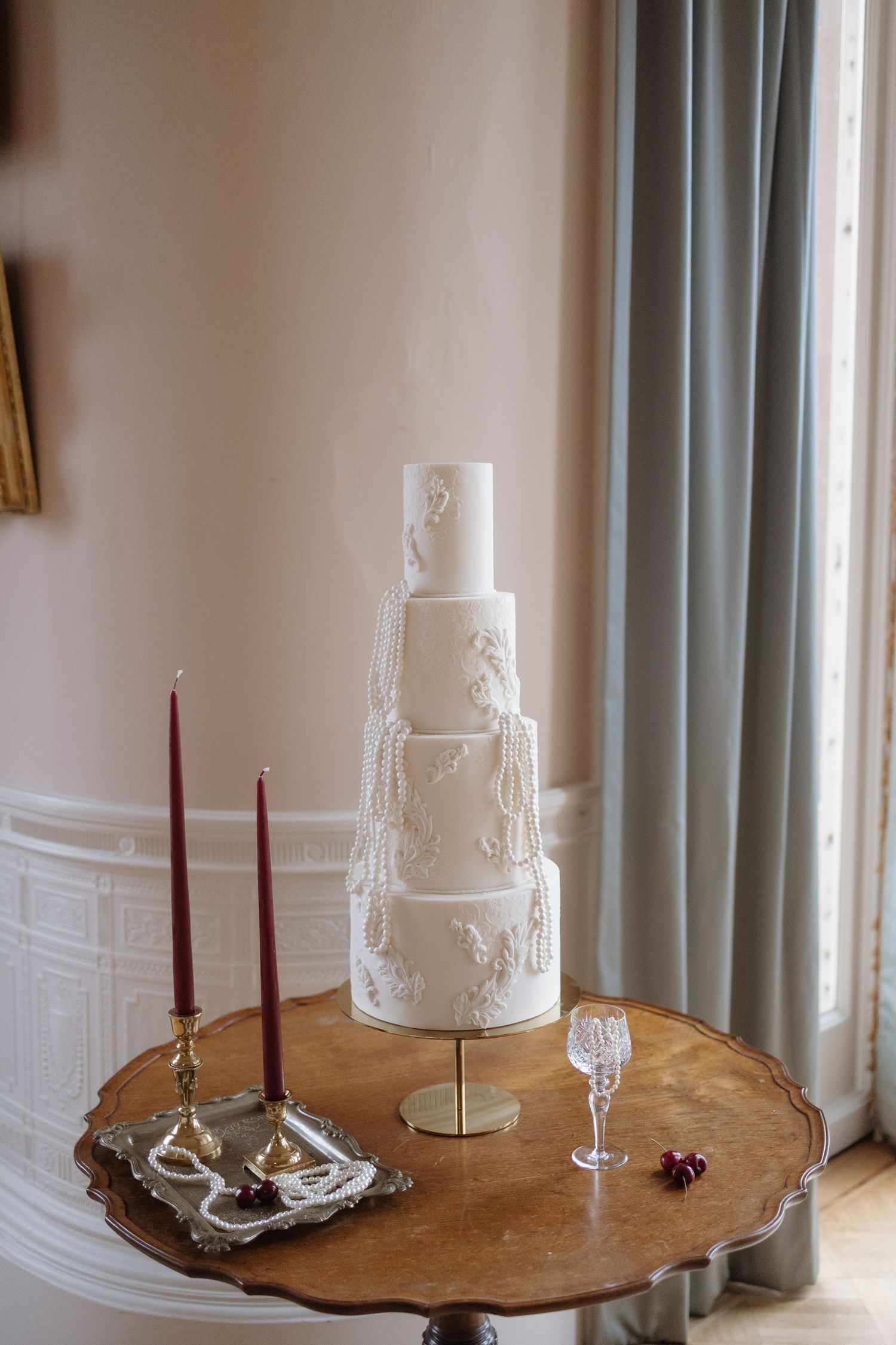 Elegant cake table surrounded by candles inside Berwick House