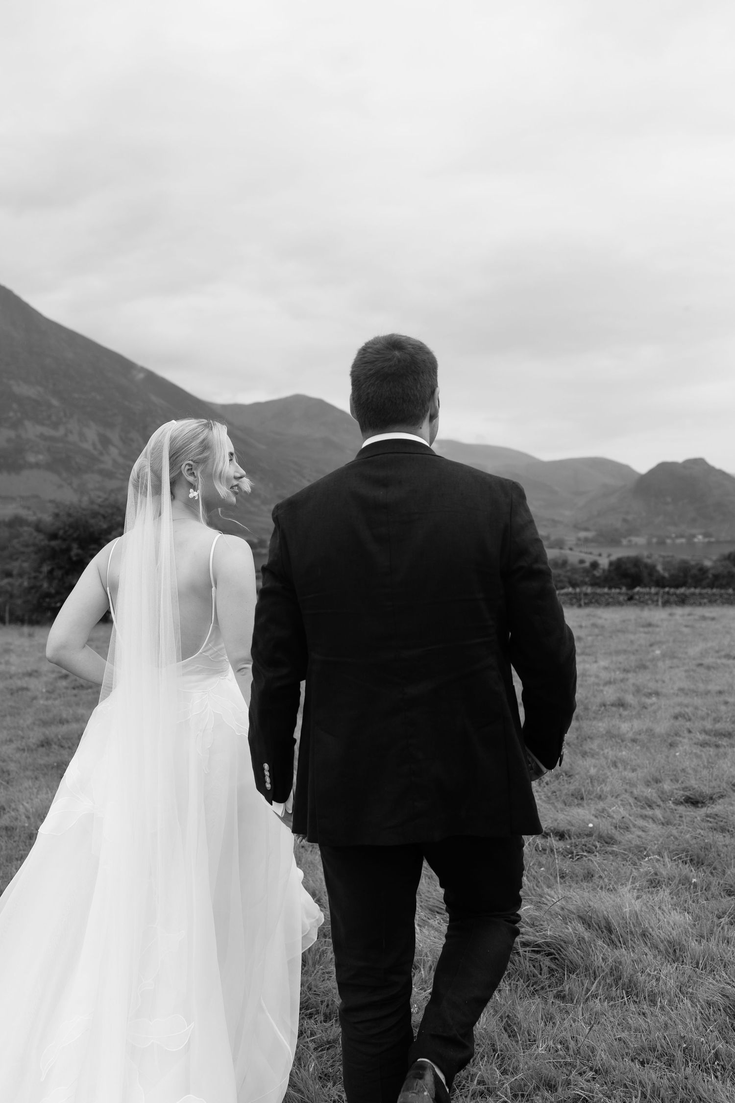 Bride and groom walking on their wedding day – Cheshire wedding photography by Lara Luis