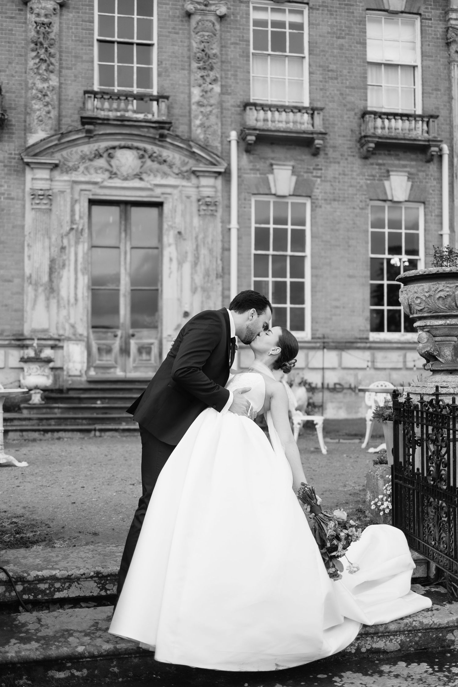 Elegant couple walking through the gardens at Berwick House in Shrewsbury