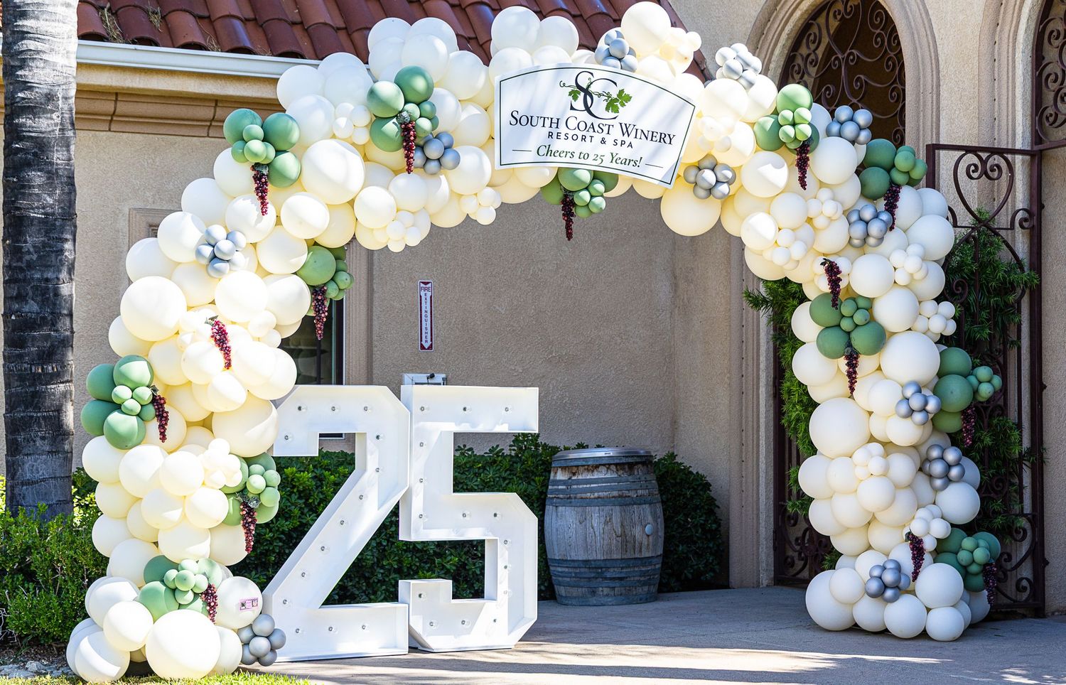 Decorative balloon arch with number 25 display at South Coast Winery anniversary celebration.