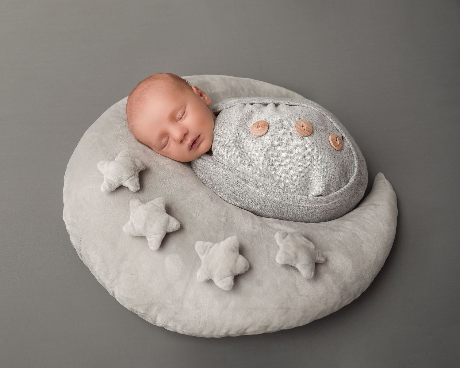 Newborn photography session in Gravesend Kent with baby lying on soft grey prop with star details