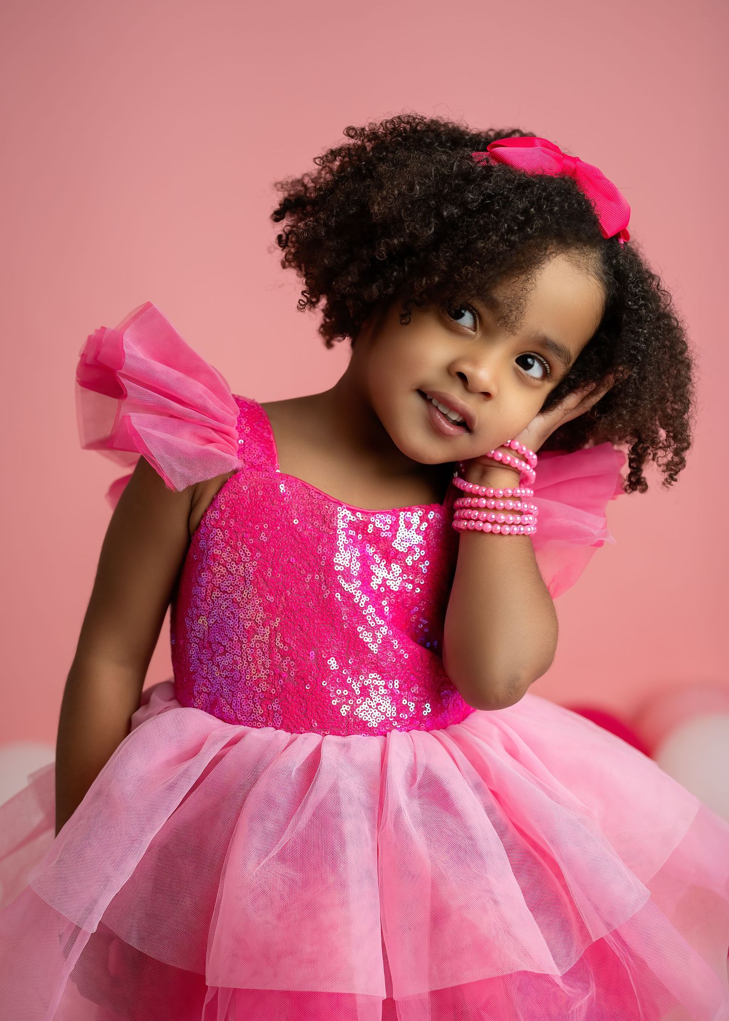 Children photography session in Gravesend Kent with little girl wearing pink dress in studio