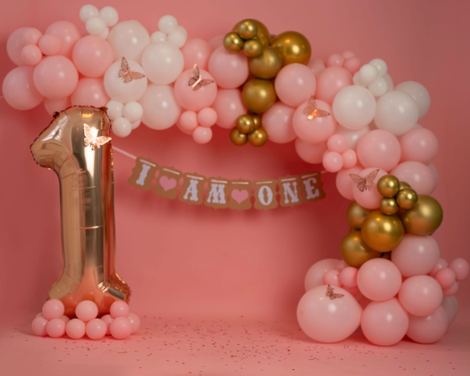 Cake smash photography session in Gravesend Kent with pink balloon setup for baby girl