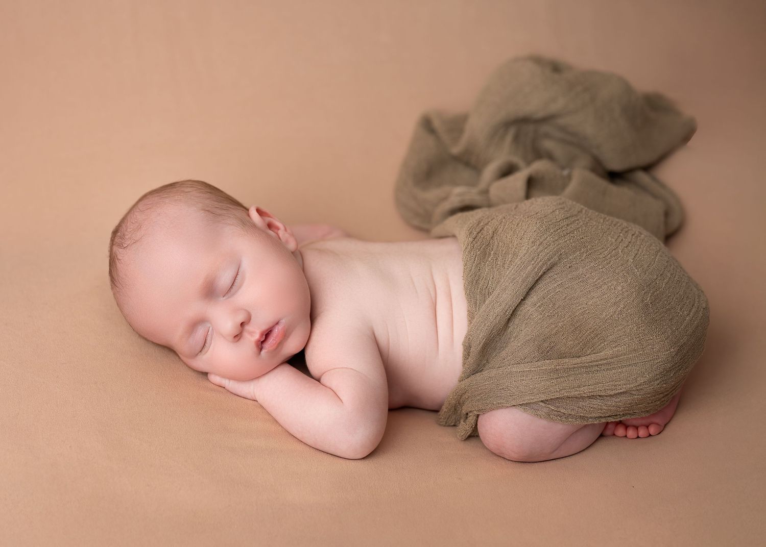 Newborn photography session in Gravesend Kent with baby sleeping on soft neutral background in studio