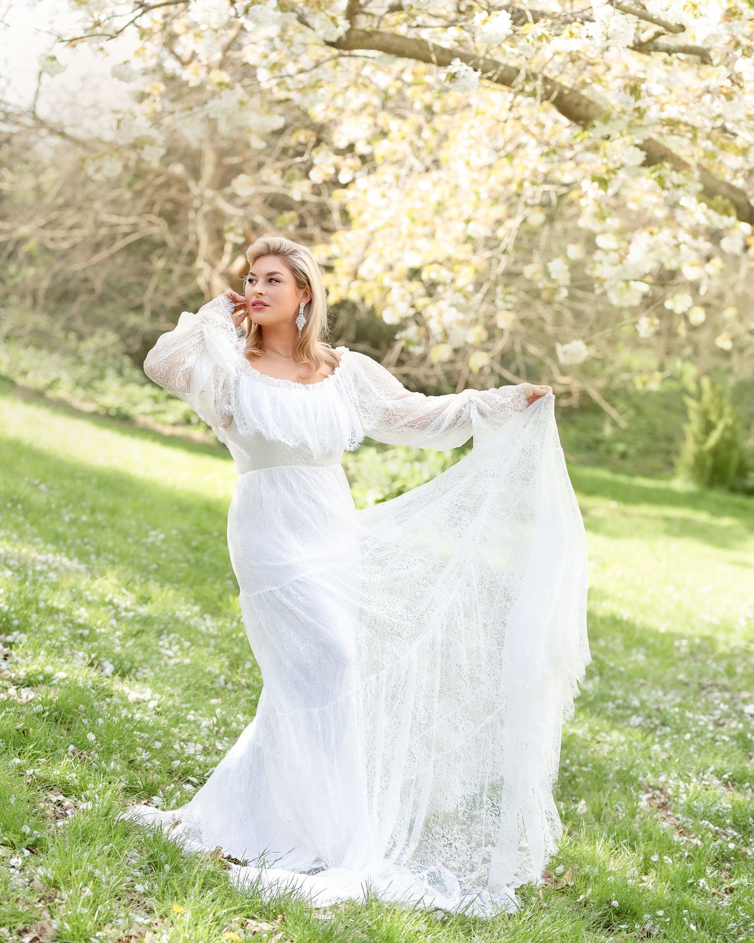 Maternity photography session in Gravesend Kent with pregnant woman in white dress standing outdoors in nature