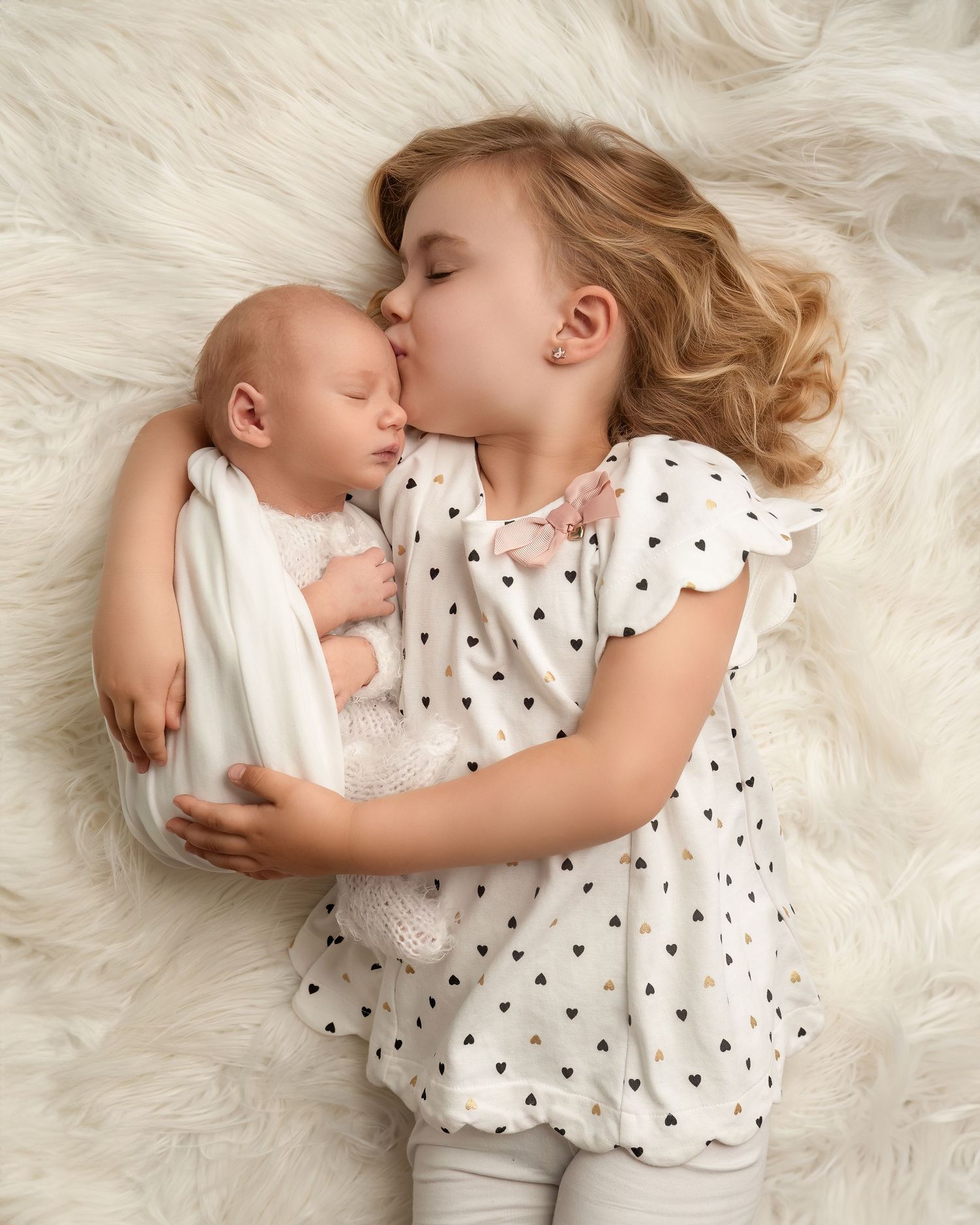 Family and newborn photography session in Gravesend Kent with sibling holding baby in studio