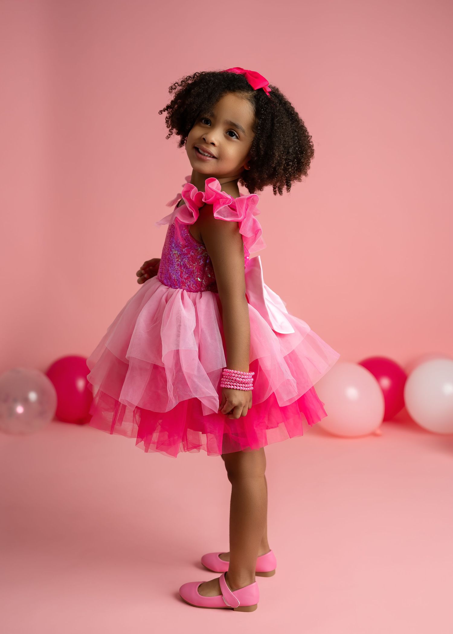 Children photography session in Gravesend Kent with little girl in pink dress full body studio portrait