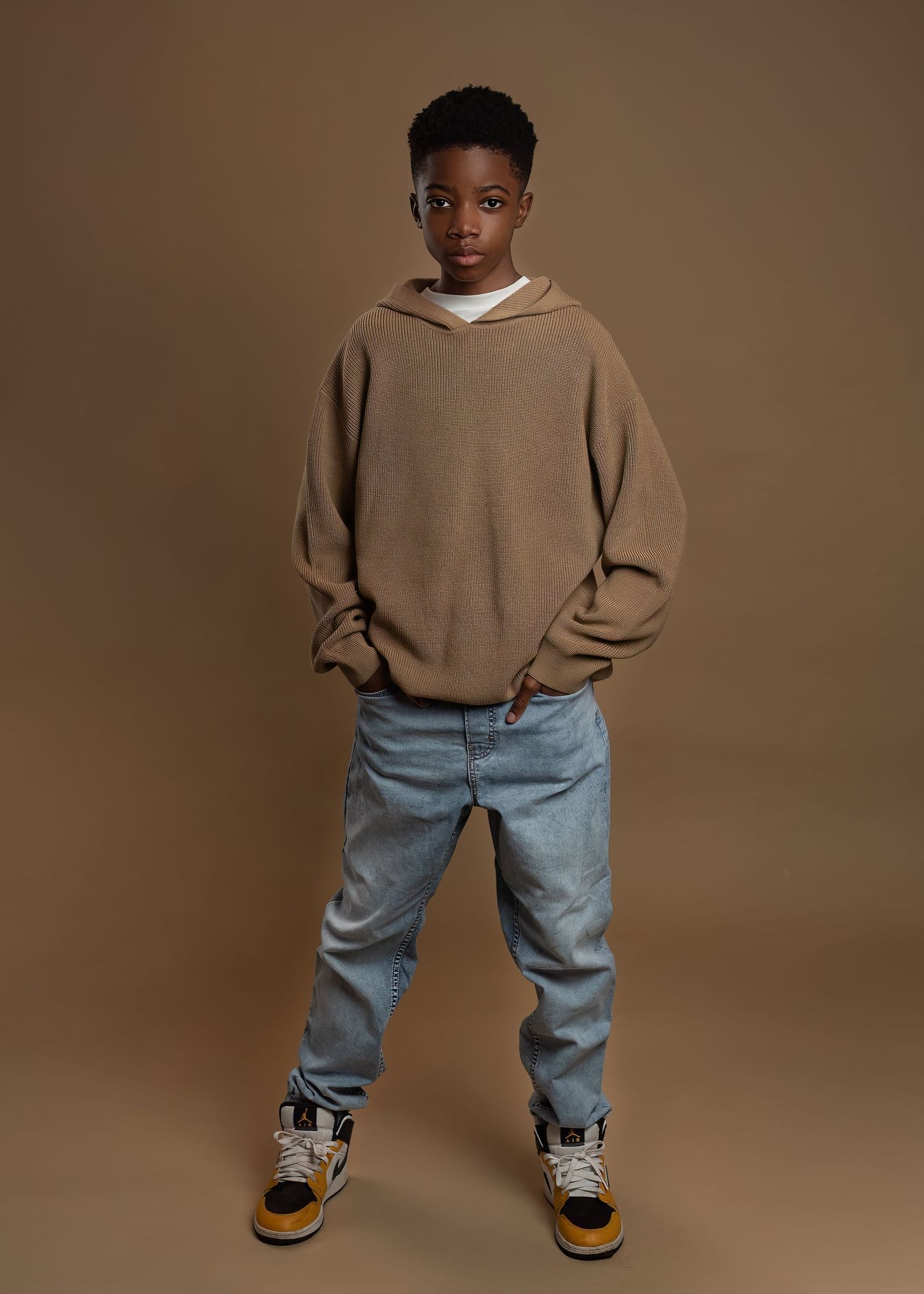 Children photography session in Gravesend Kent with boy standing in casual outfit in studio