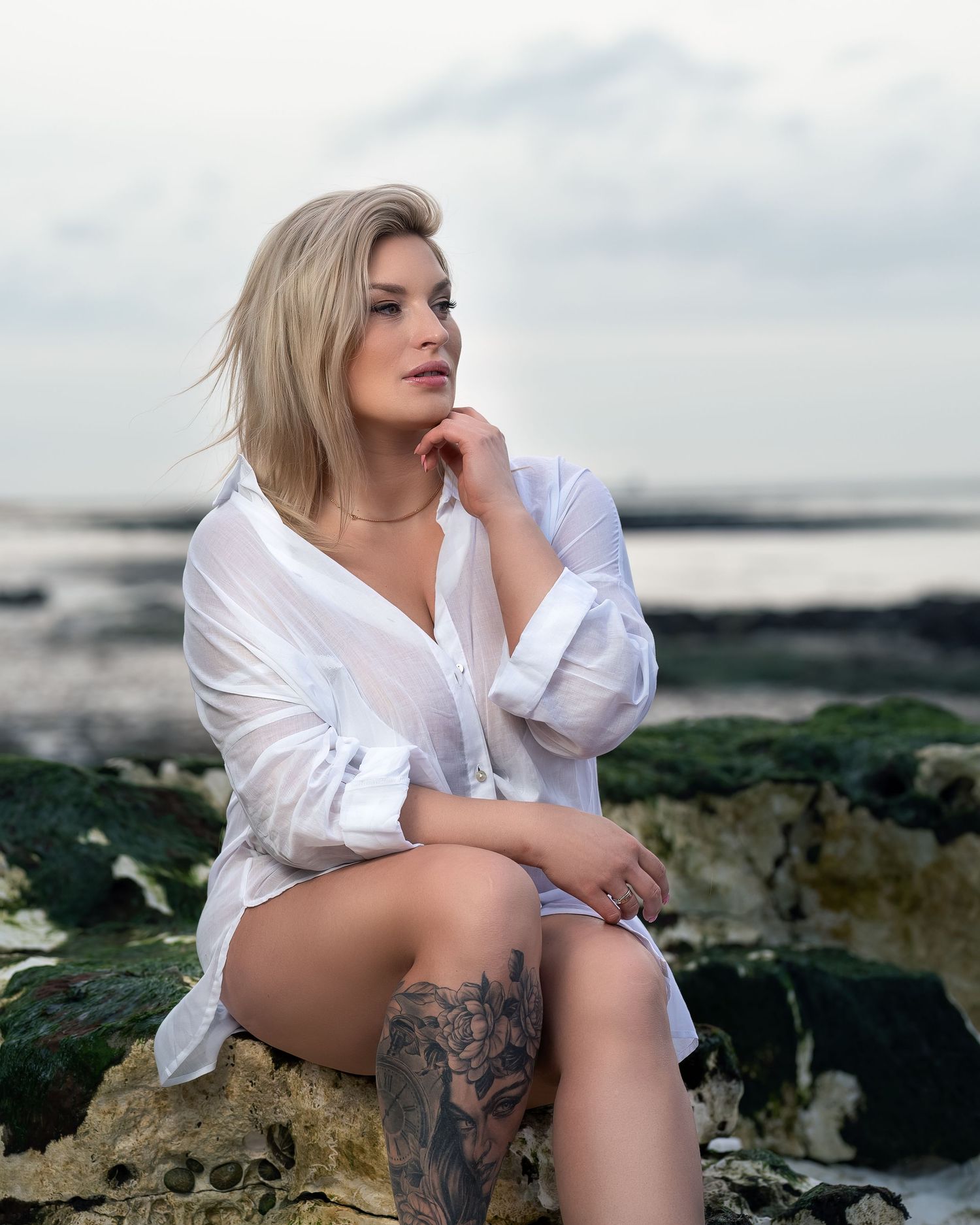 Outdoor portrait photoshoot in Gravesend Kent with woman sitting on rocks by the sea