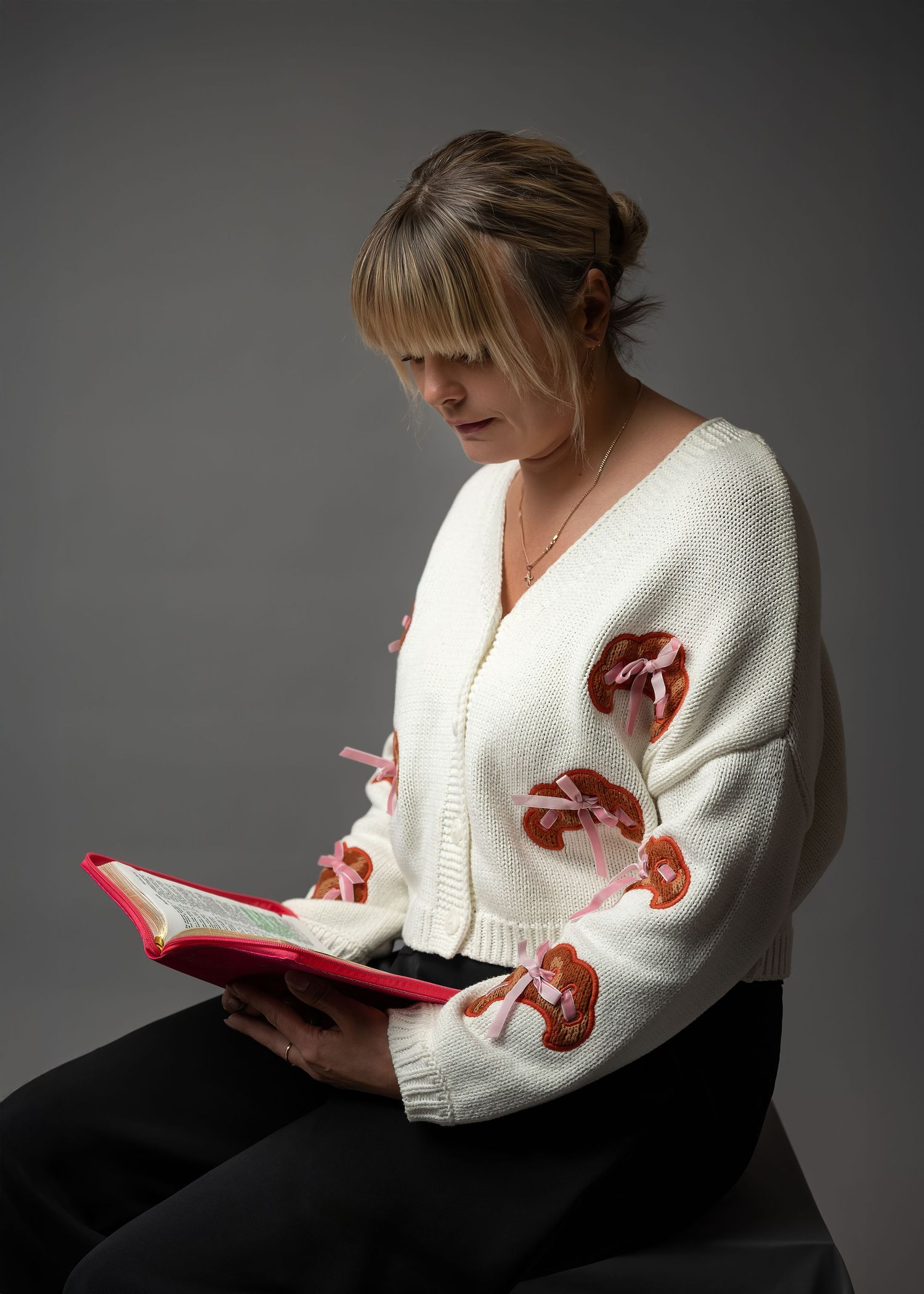 Portrait photography in Gravesend Kent with woman sitting and reading in soft studio lighting