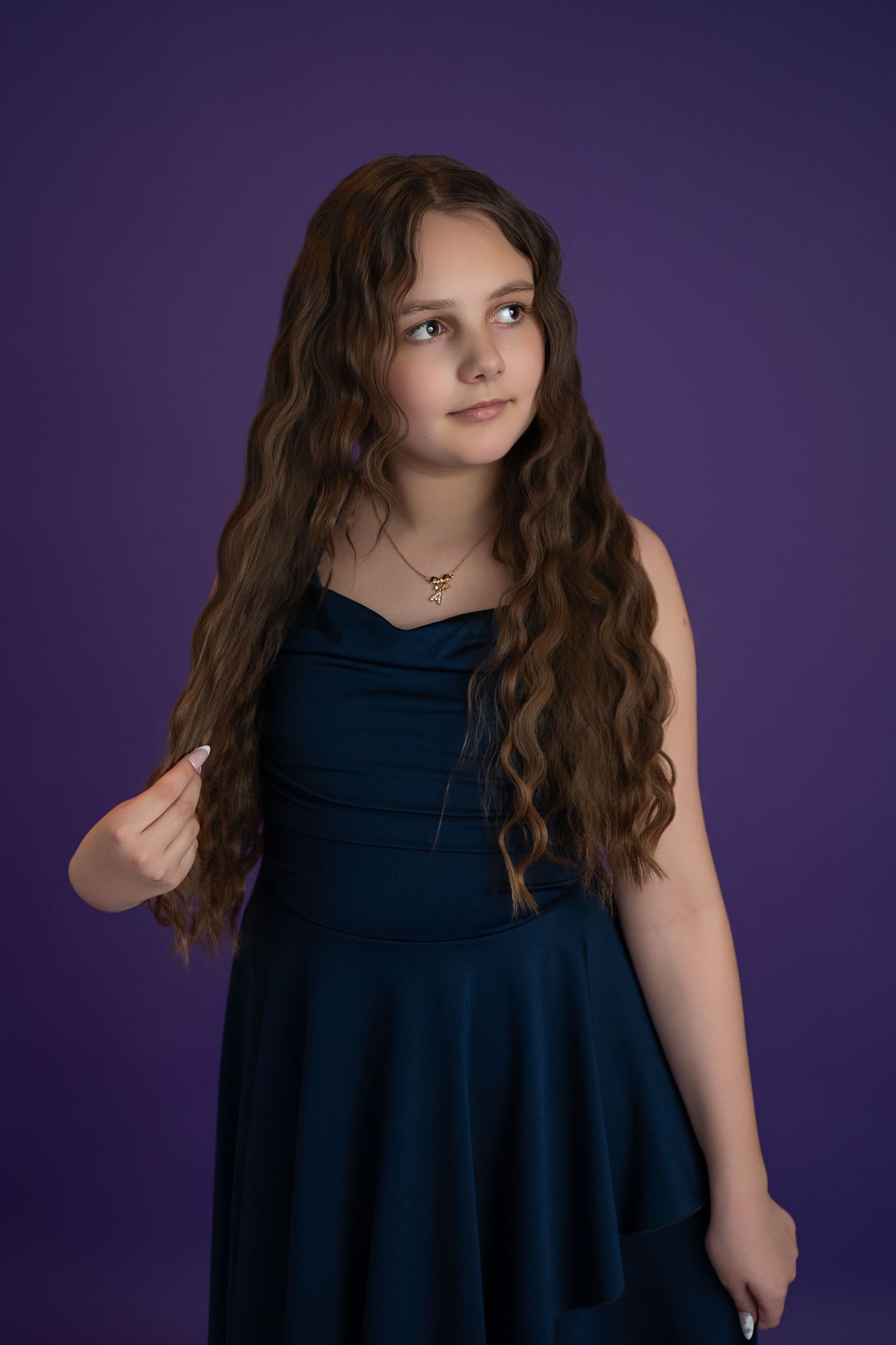Child portrait photography in Gravesend Kent with girl in blue dress on purple background